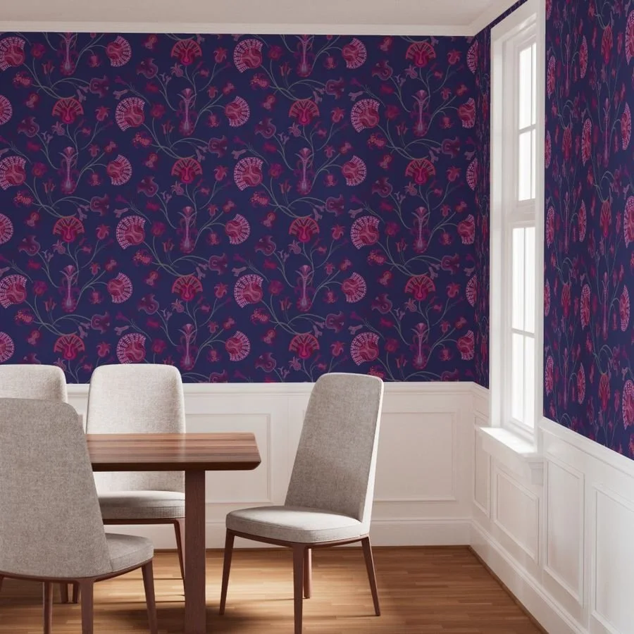 Deep blue wallpaper with glowing pink branching tulip-inspired bouquets cover the upper portion of a wall, with white wainscoting in a brightly lit room with a contemporary dining set upon a warm light wood floor 