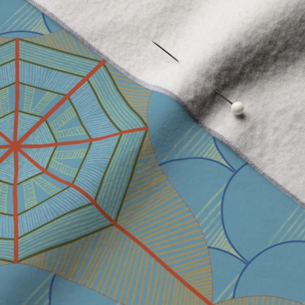 Compass rose and fish scale inspired pattern on a cloth with a dress-makers pin