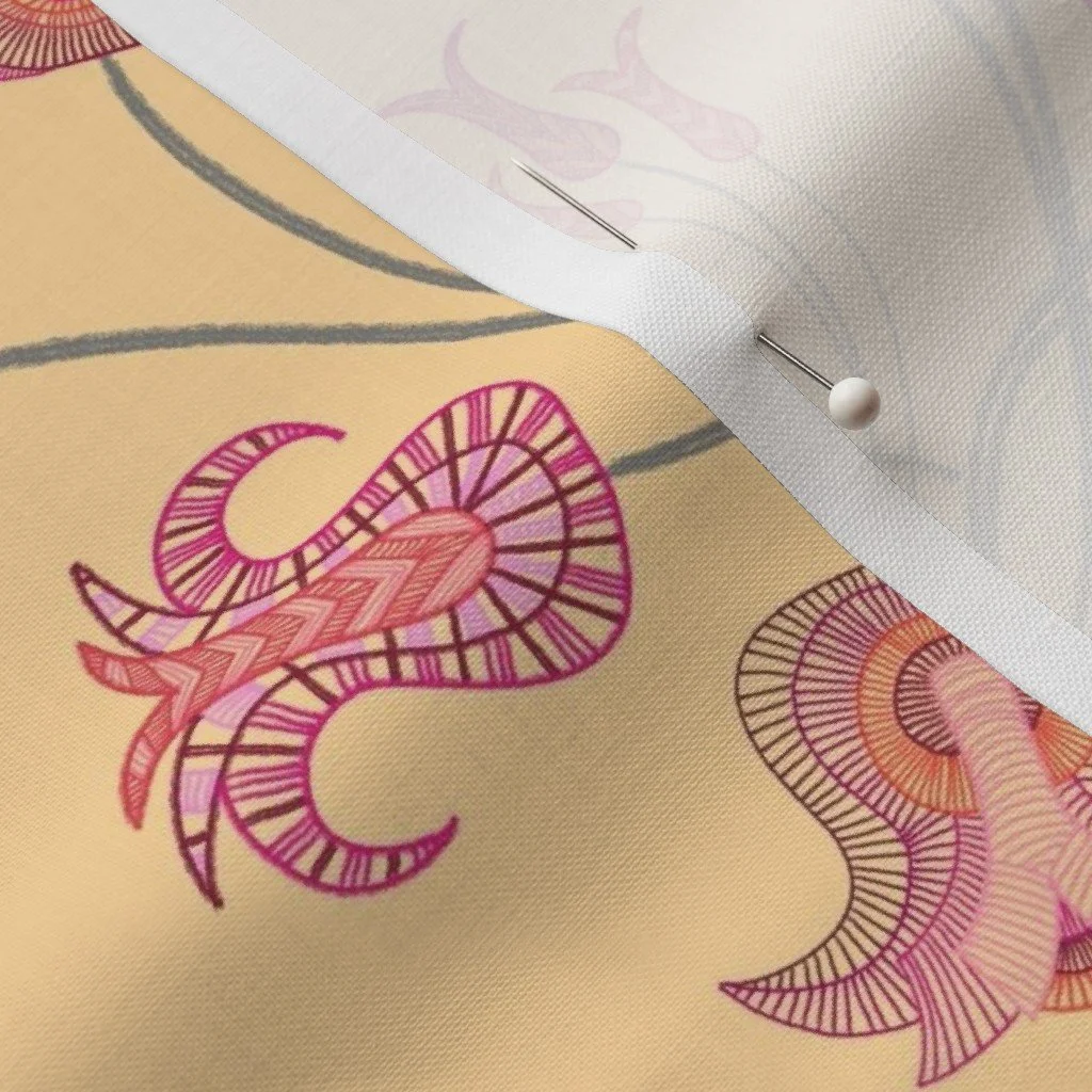Whimsical tulips meander and sprout with detailed vibrancy against a warm yellow ground on a piece of silk with a dressmaker's pin