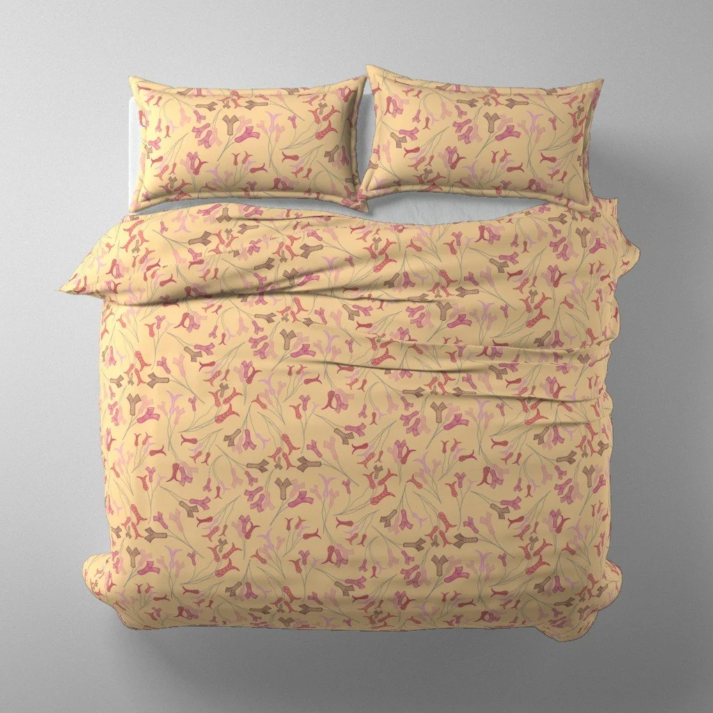 Abstract tulip stamens dance across warm yellow duvet and pillows on a bed viewed from above