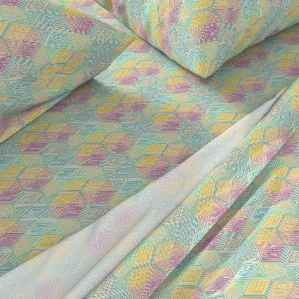 Rainbow hexagon maze pattern glows upon bed sheets and pillows.