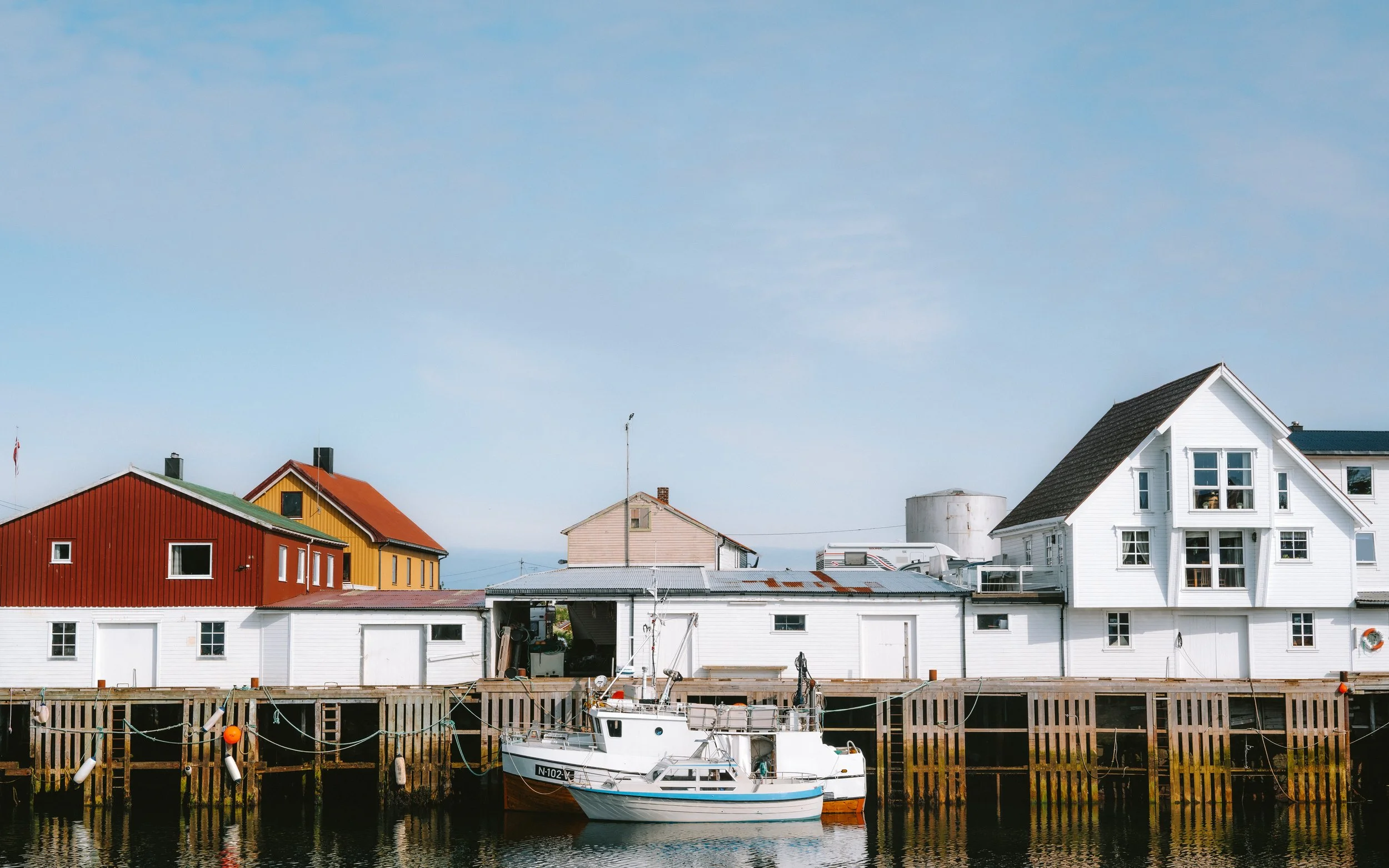 Harbor with colorful houses and a boat docked in the water