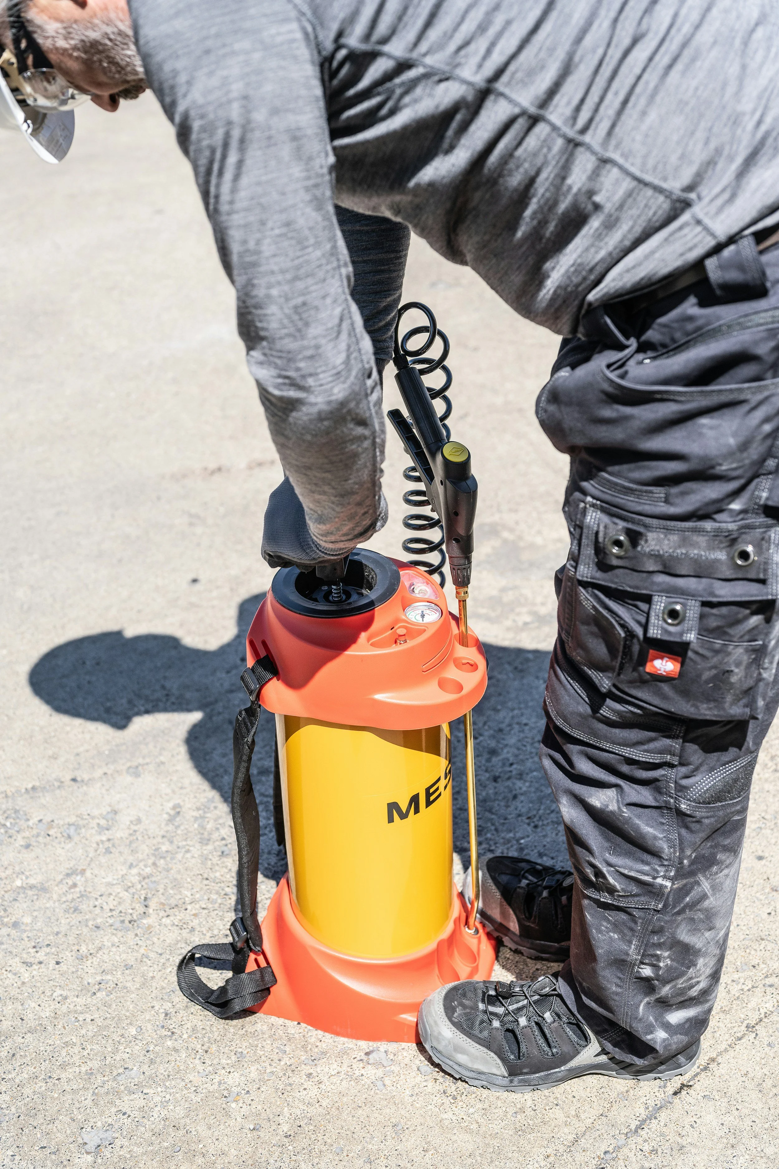 Pest control professional with a sprayer pump