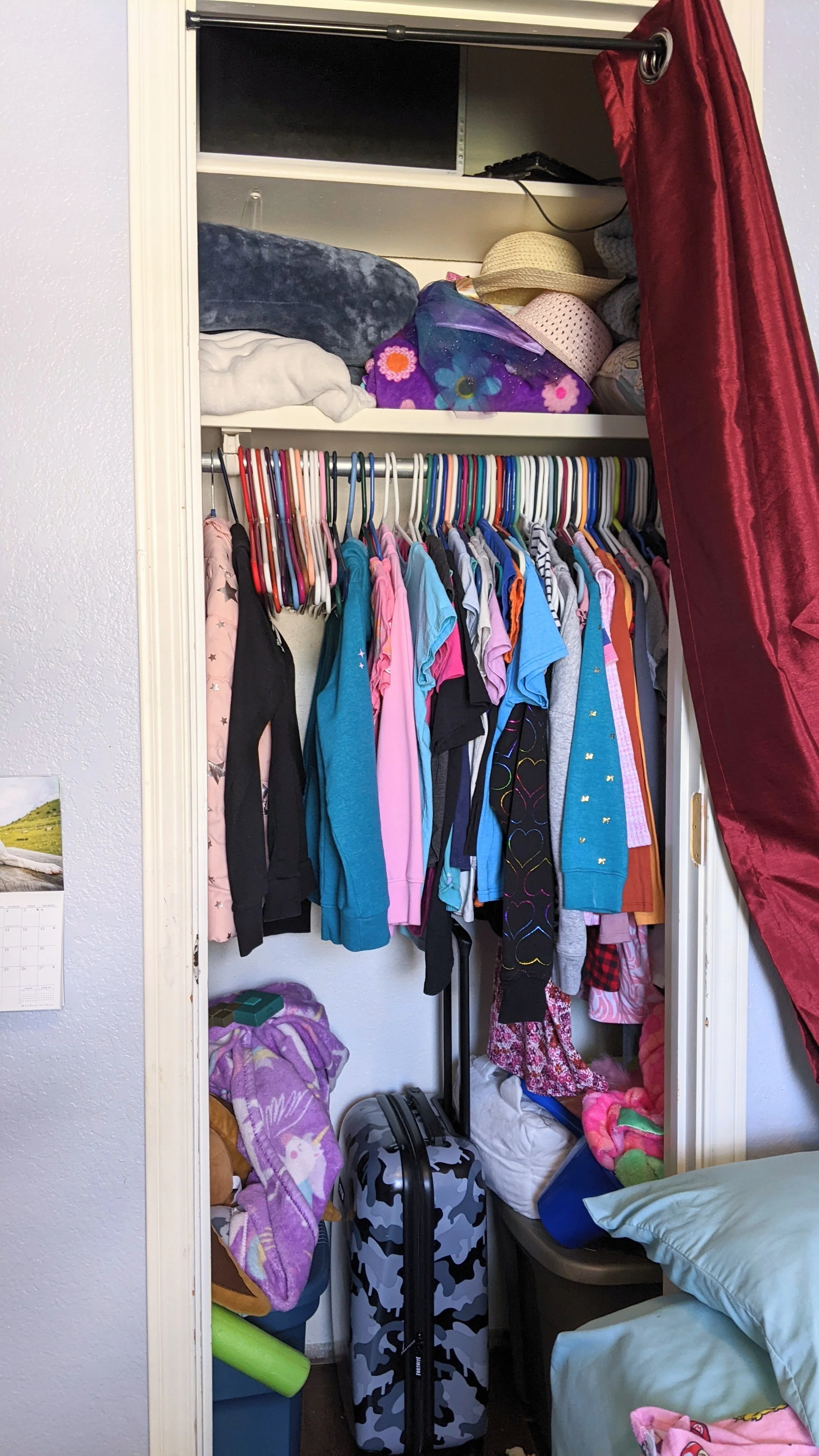 Girl's bedroom closet before sorting and organizing