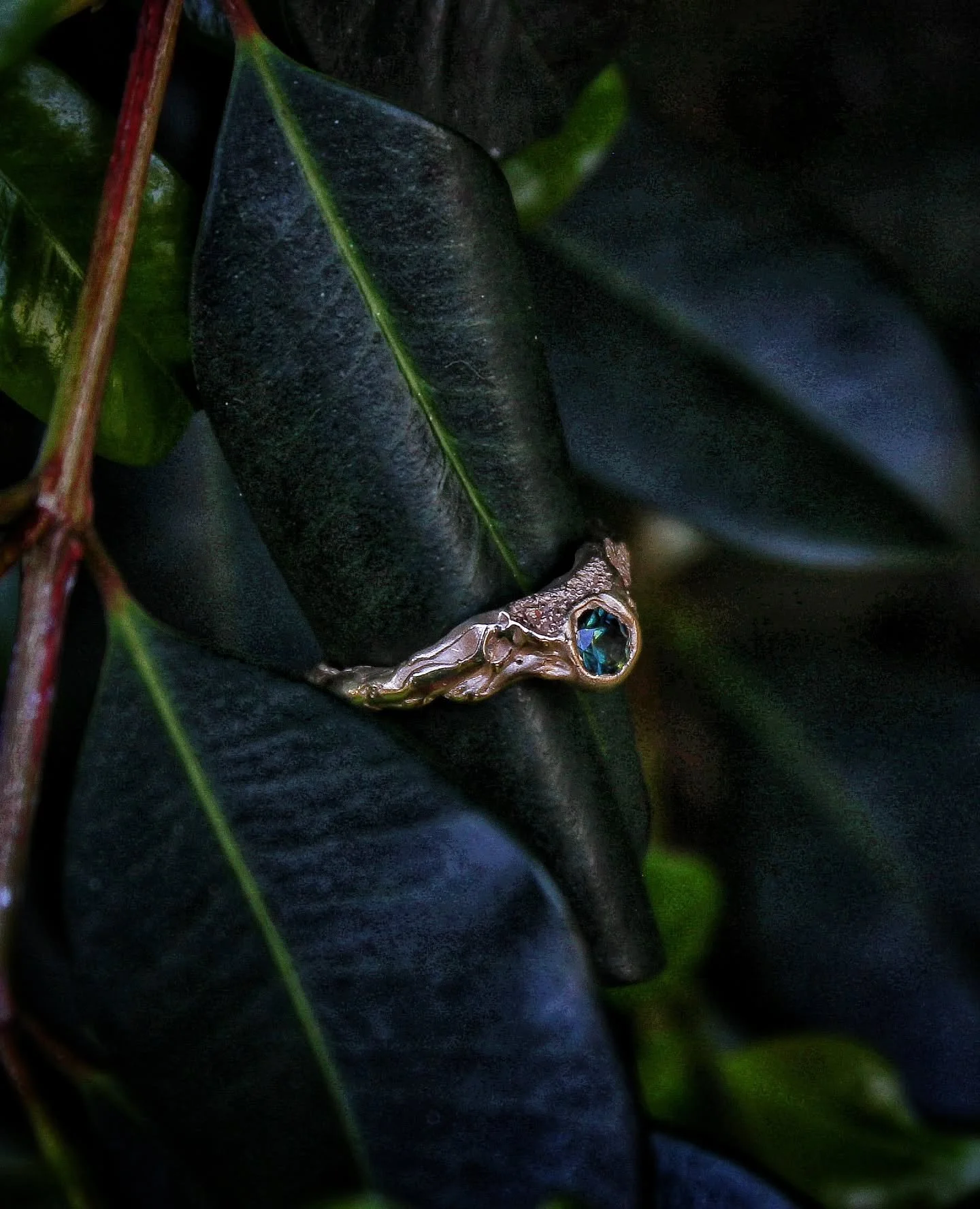 Imprinted with sand and shaped by flame.

This 9k solid gold ring showcases a stunning green blue set-in-place sapphire, and textures that echo tides, shorelines, and moving water. 

She's a piece holding the energy of the ocean; grounding, cleansing