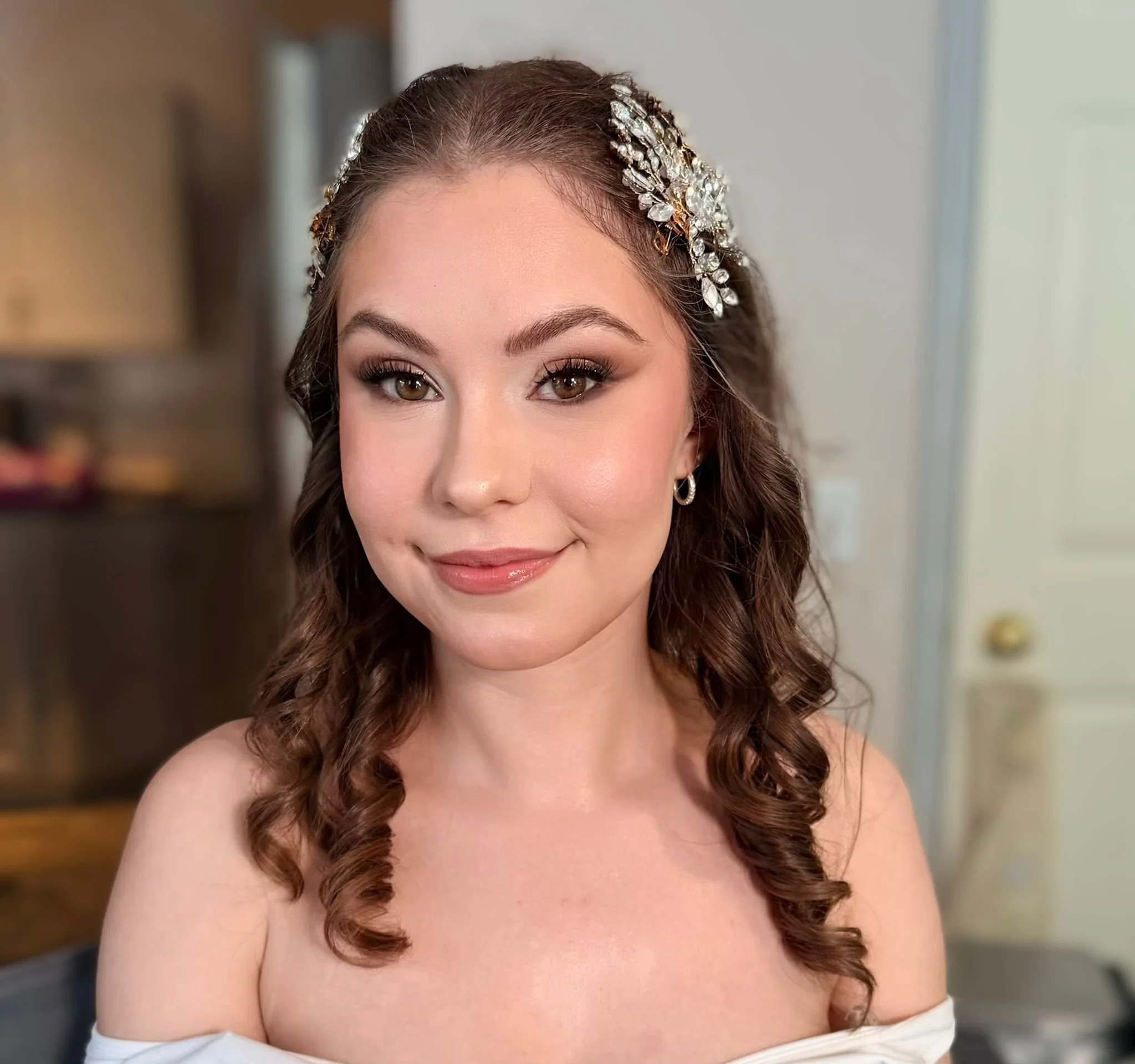 Bridesmaid hairstyle with pearl hair accessories and soft glam makeup.