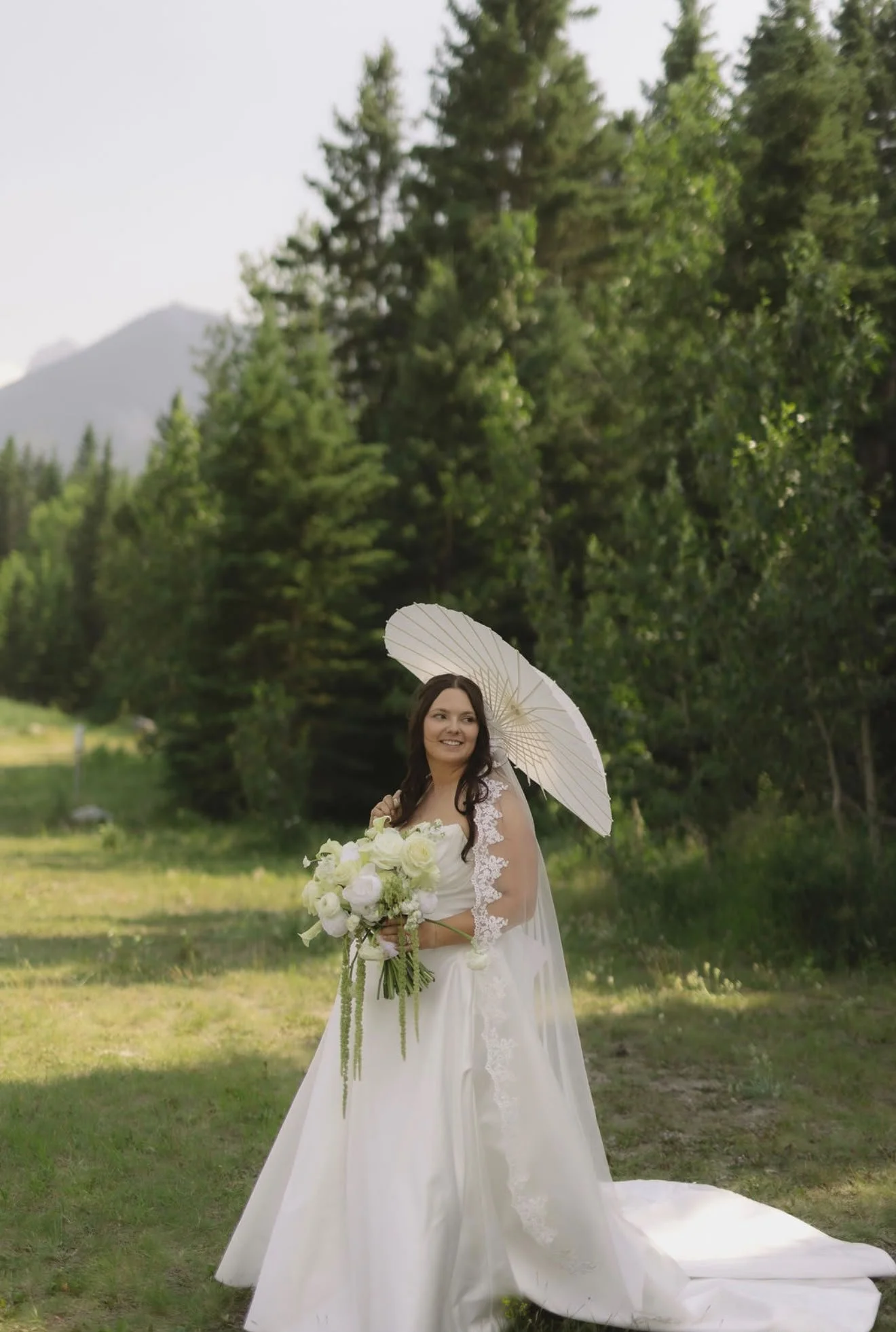 Bride featuring soft, glowing bridal makeup and elegant wedding hair styling by North of Blush at an outdoor mountain wedding in Banff and Canmore, Alberta.