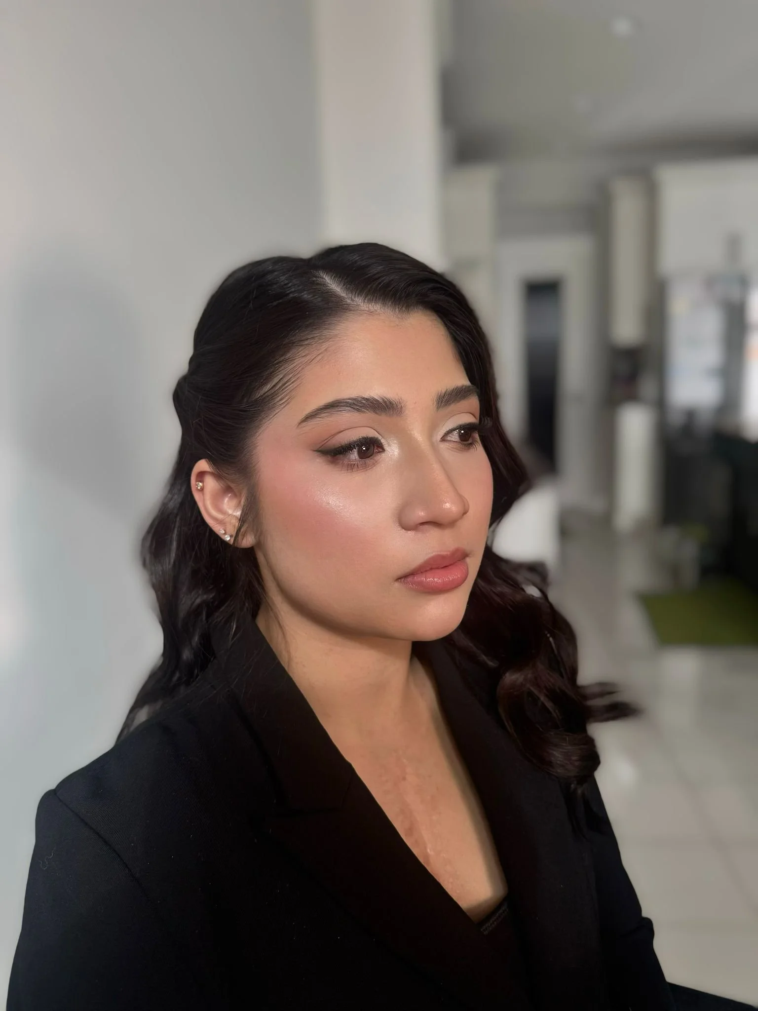 Profile view of Indian bridesmaid with soft glam makeup and gold jewelry.