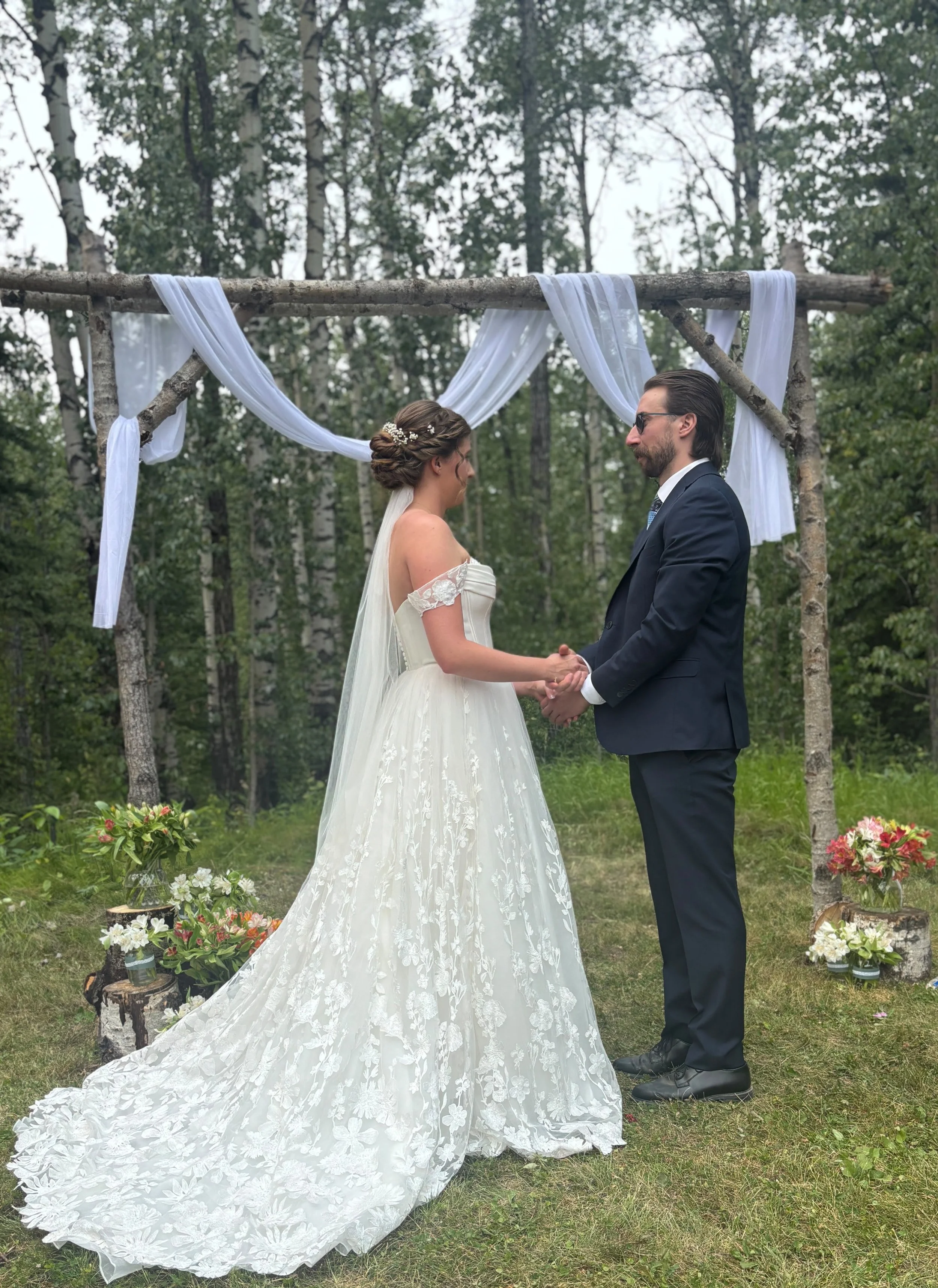 Bride with elegant bridal hair and mobile makeup styling by North of Blush at an outdoor wedding ceremony in Canmore and Banff, Alberta.