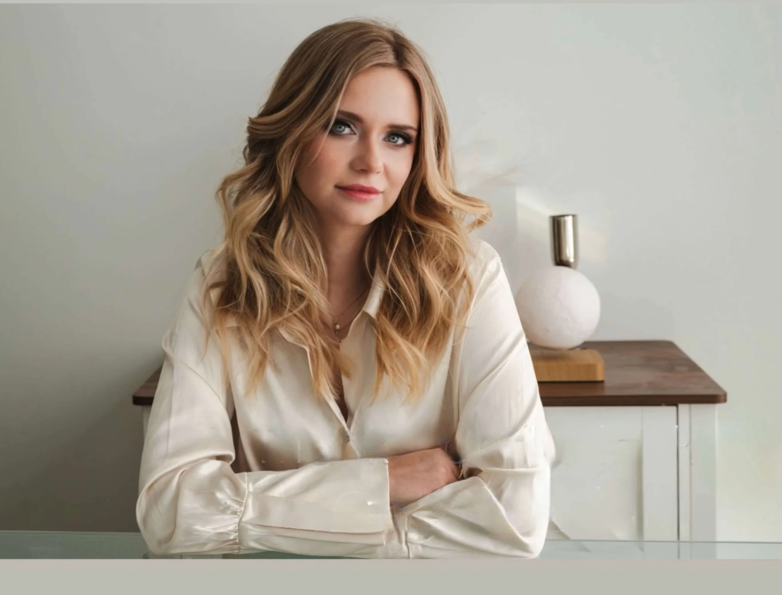 Soft, natural makeup with even skin, lightly defined brows, subtle eye makeup, gentle blush, and muted pink lips.