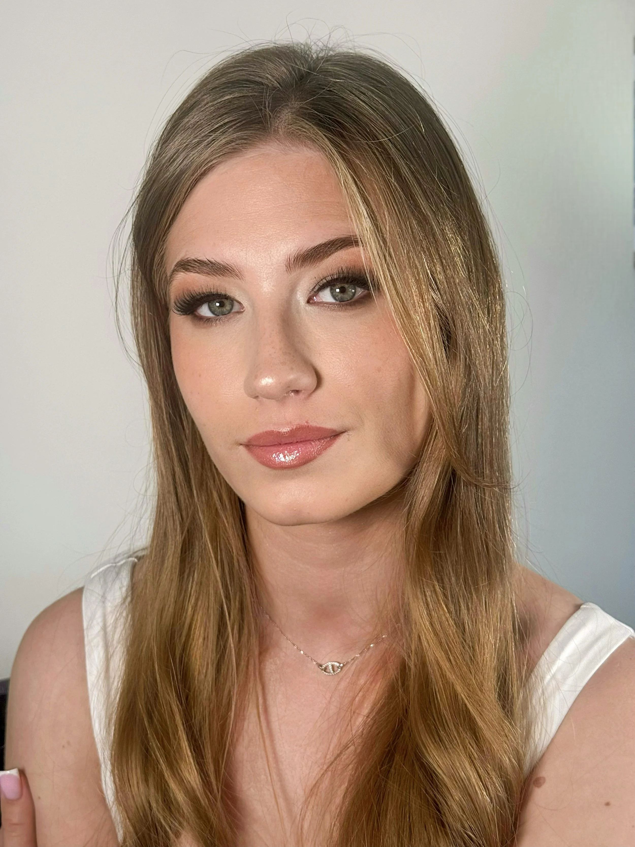 Smiling blonde bride with natural glam makeup.