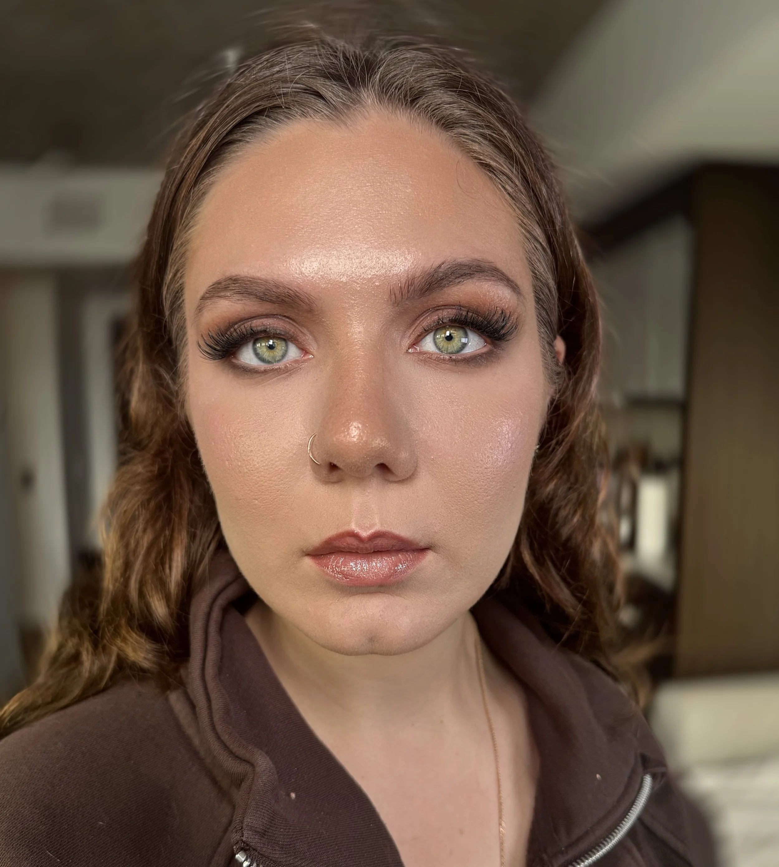 Close-up of high glam makeup application with dewy, radiant finish.