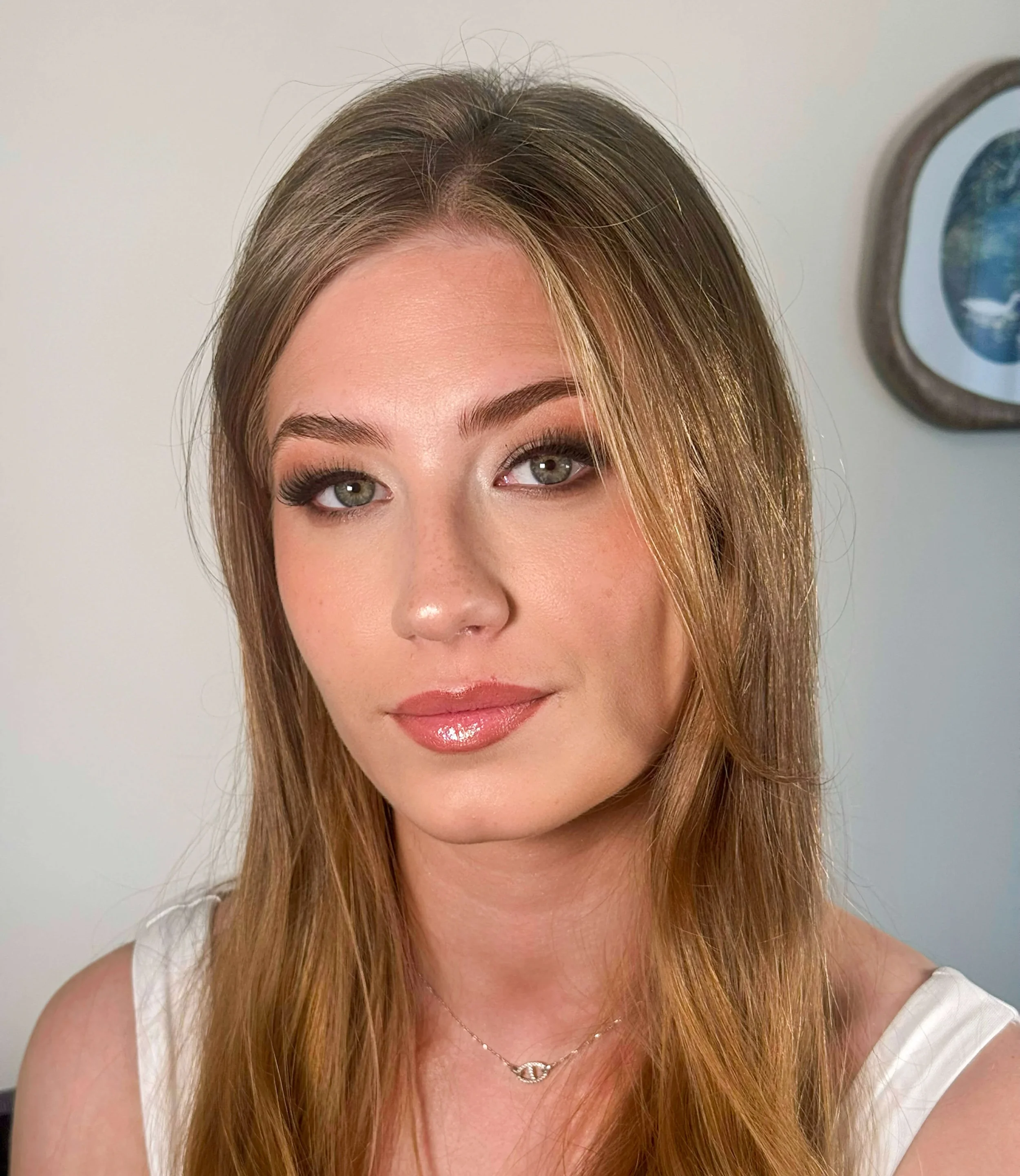 Close-up portrait of a woman with professional natural makeup application by North of Blush, featuring a soft, glowing complexion and subtle eye makeup.