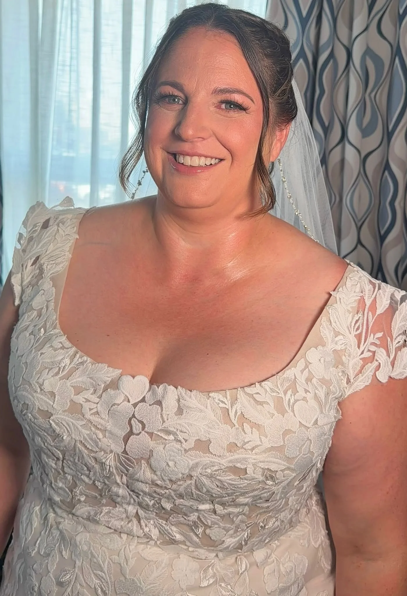 Bride in a detailed lace gown with elegant bridal hair and makeup styling by North of Blush, serving Lethbridge, Red Deer, and surrounding Alberta communities.