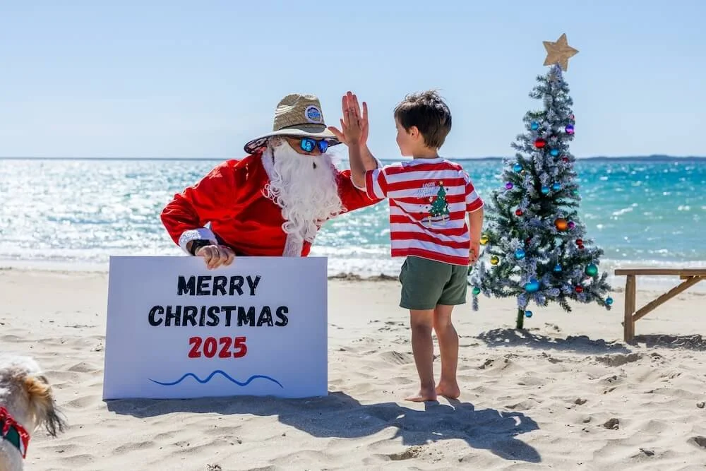 Fun, action packed Santa photos on the beach in Perth, WA