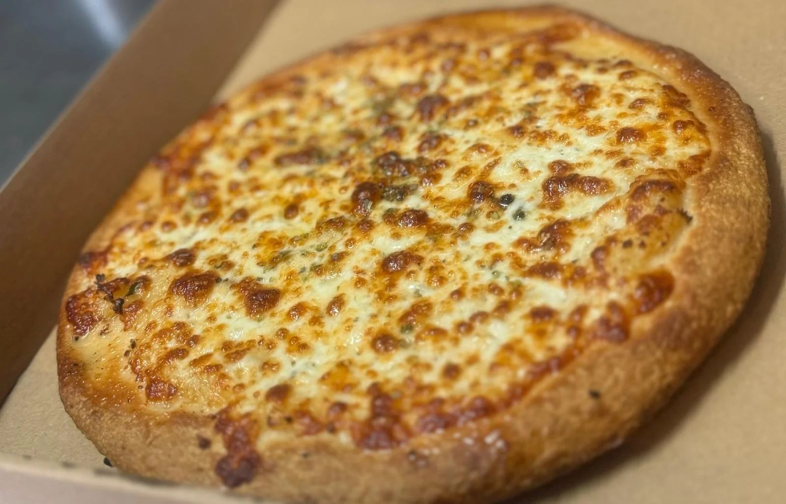 Jessie's Pizza Cheese pizza in a cardboard box. best pizza in Point Cook