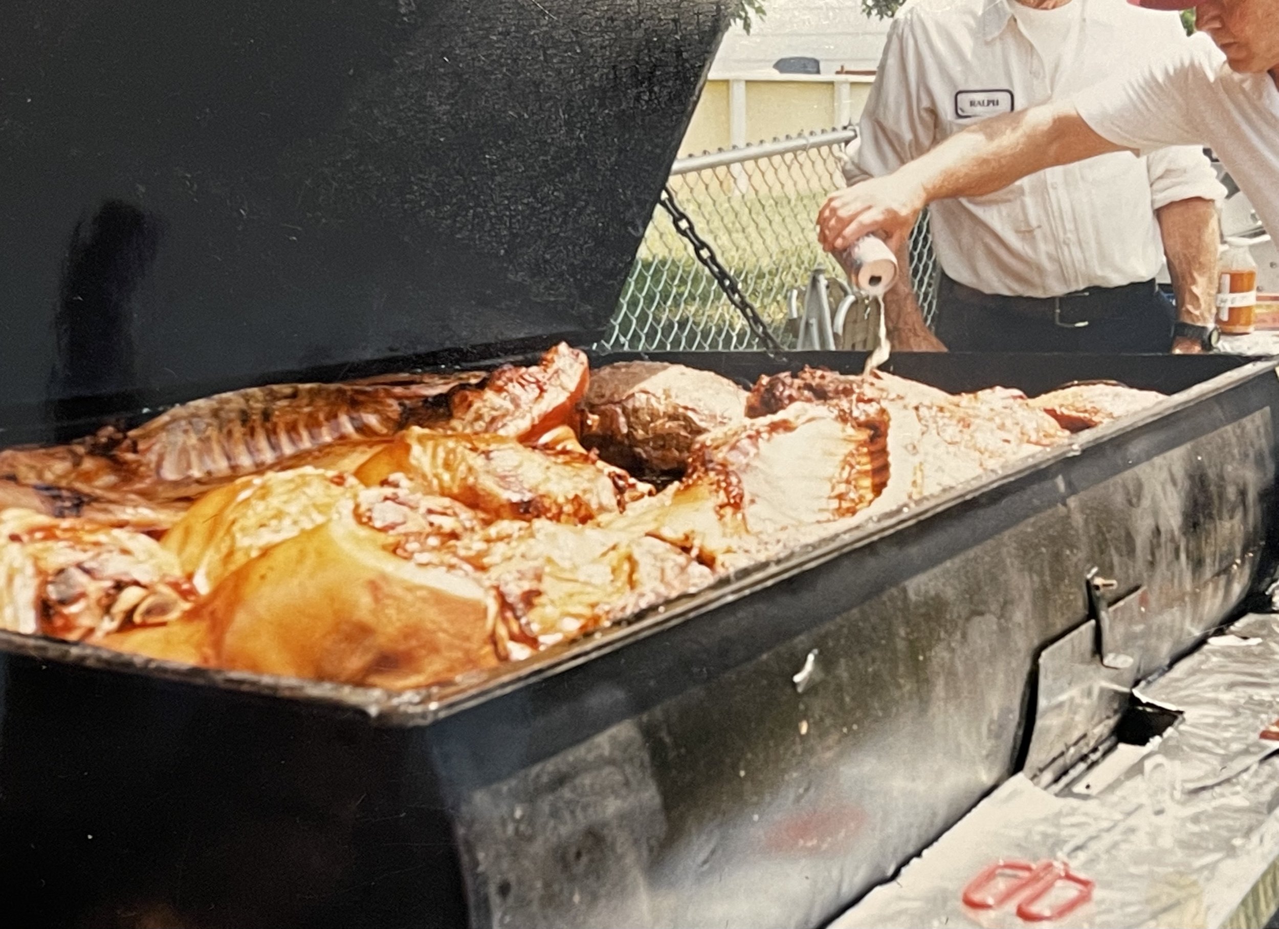 Dad's pouring beer on the pig?