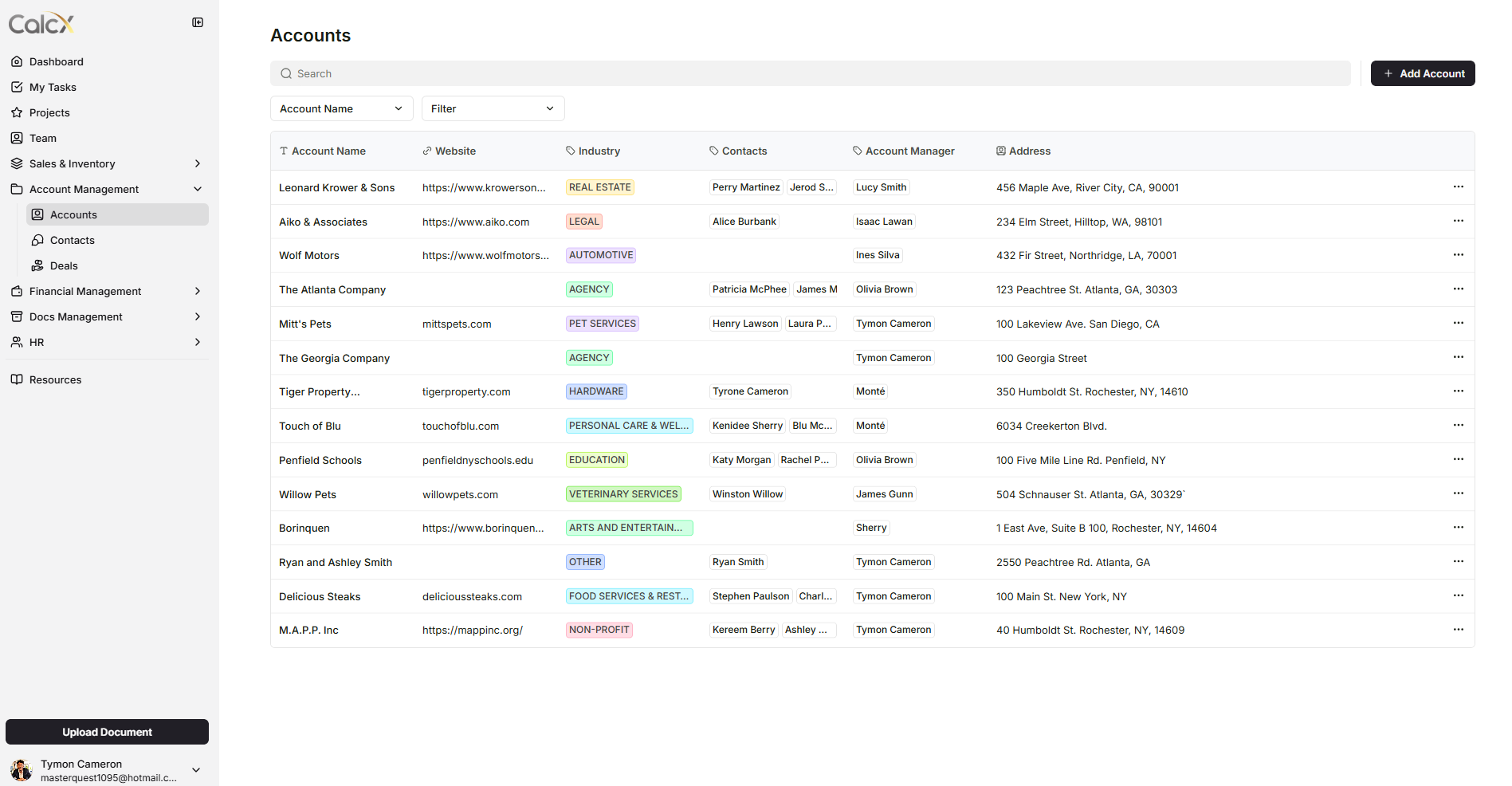 Screenshot of a web application displaying a list of accounts with columns for account name, website, industry, contacts, account manager, and address. The menu on the left includes options like Dashboard, My Tasks, Projects, Team, and more. There are buttons for adding accounts and uploading documents. User information at the bottom left shows the name Tymon Cameron and an email address.