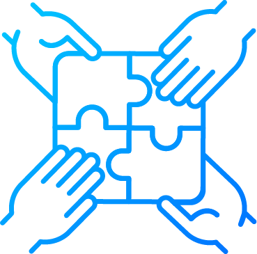 Four hands working together to assemble a puzzle.