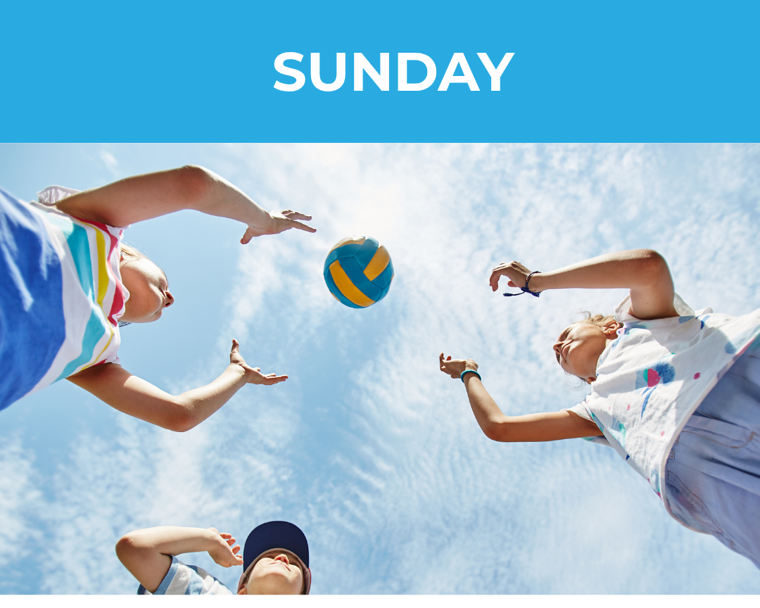 Children playing volleyball outdoors on a sunny day with a bright blue sky and scattered clouds.