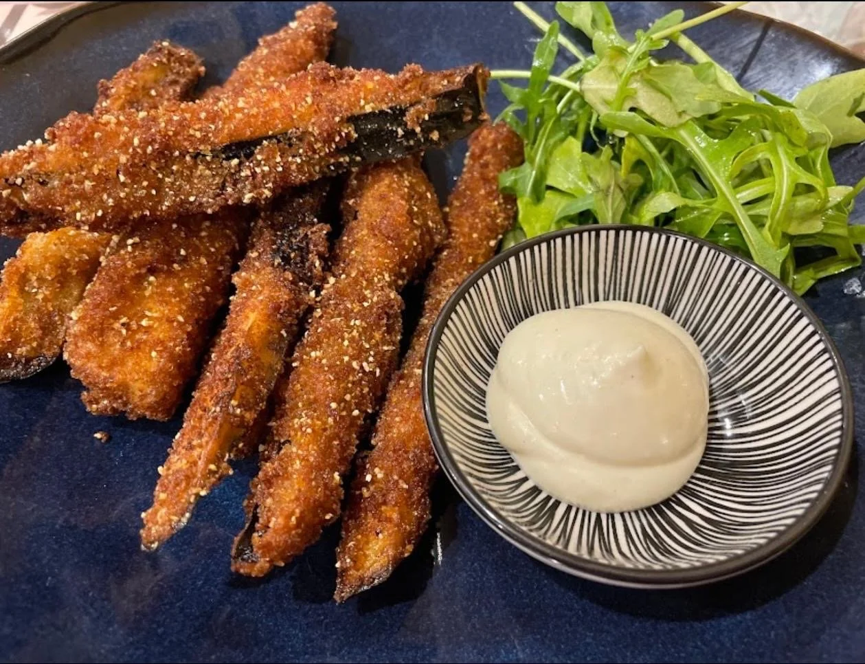 Polenta crumbed long eggplant chips entree served with BBQ aioli dipping sauce.