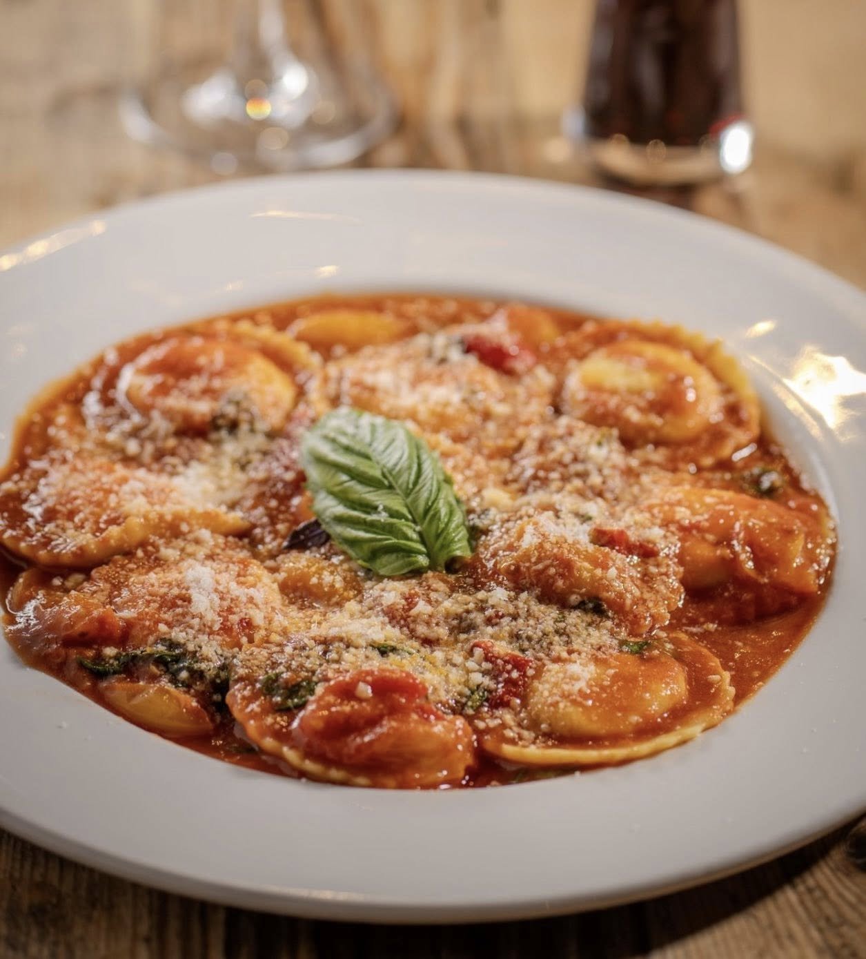 Ravioli Napoli with garlic, fresh basil, and grated Grana Padano cheese.