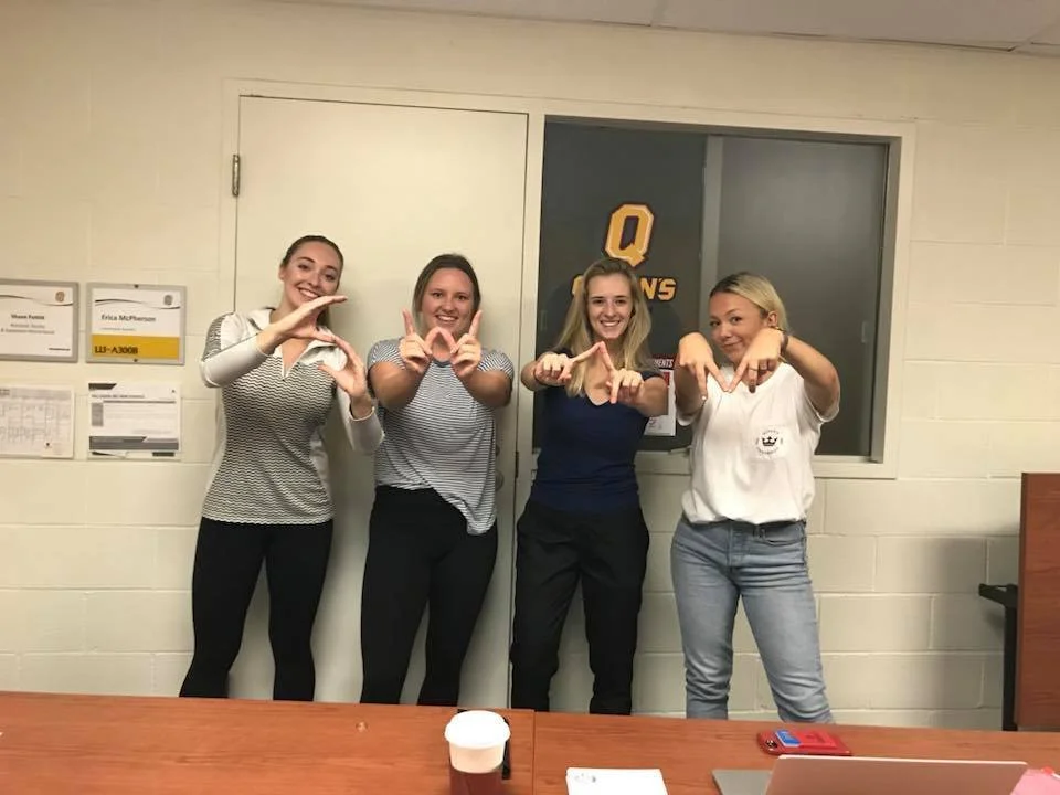 SWAM Kingston volunteers spelling "SWAM" with their hands