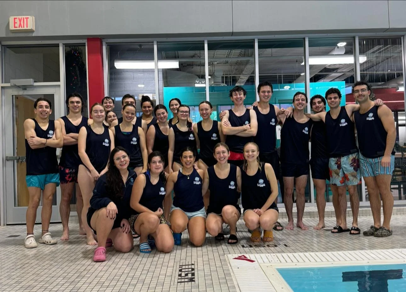 group of SWAM instructors wearing matching uniforms smiling at the camera