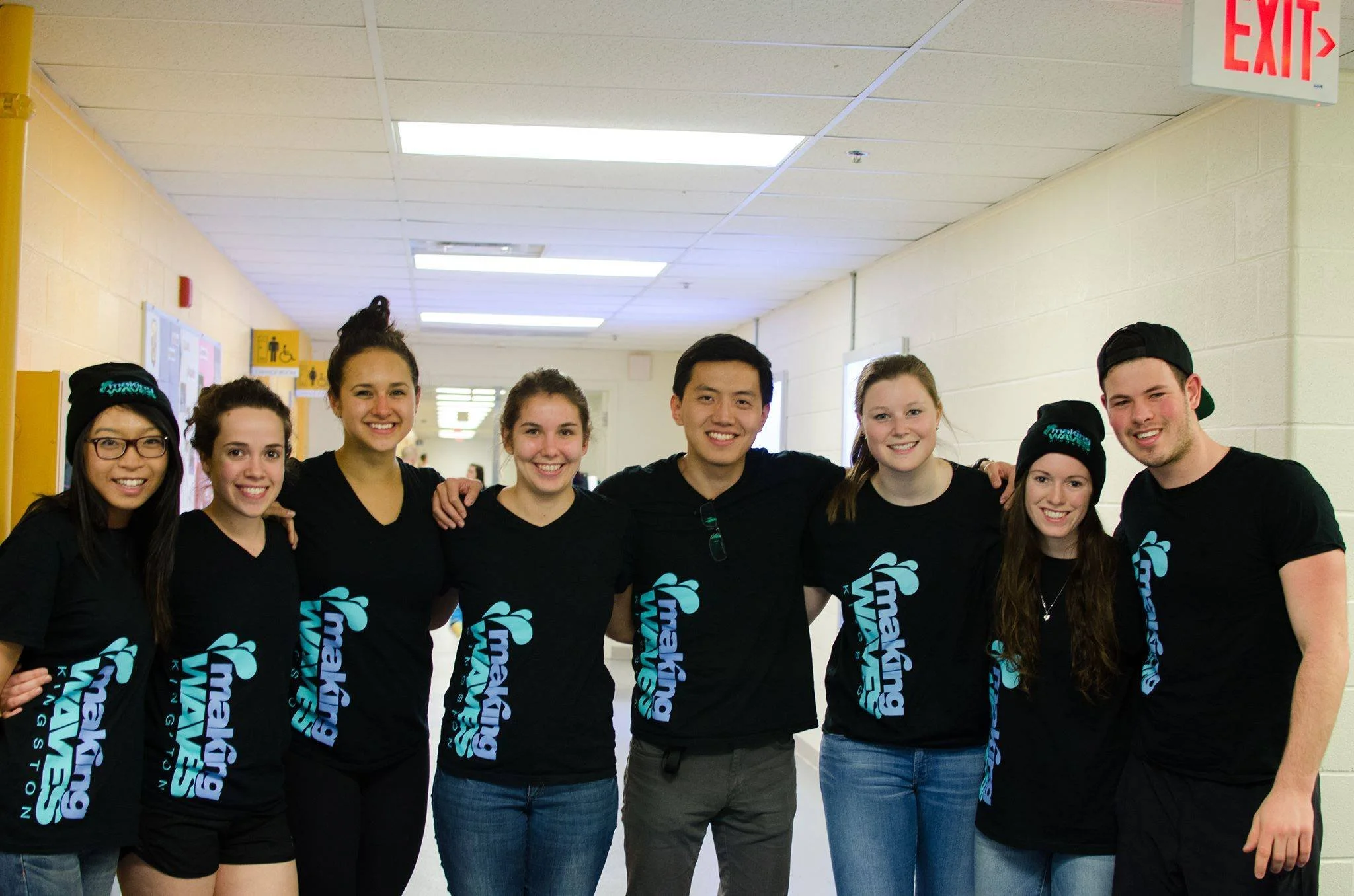 group of smiling volunteers with shirts that say "Making Waves"
