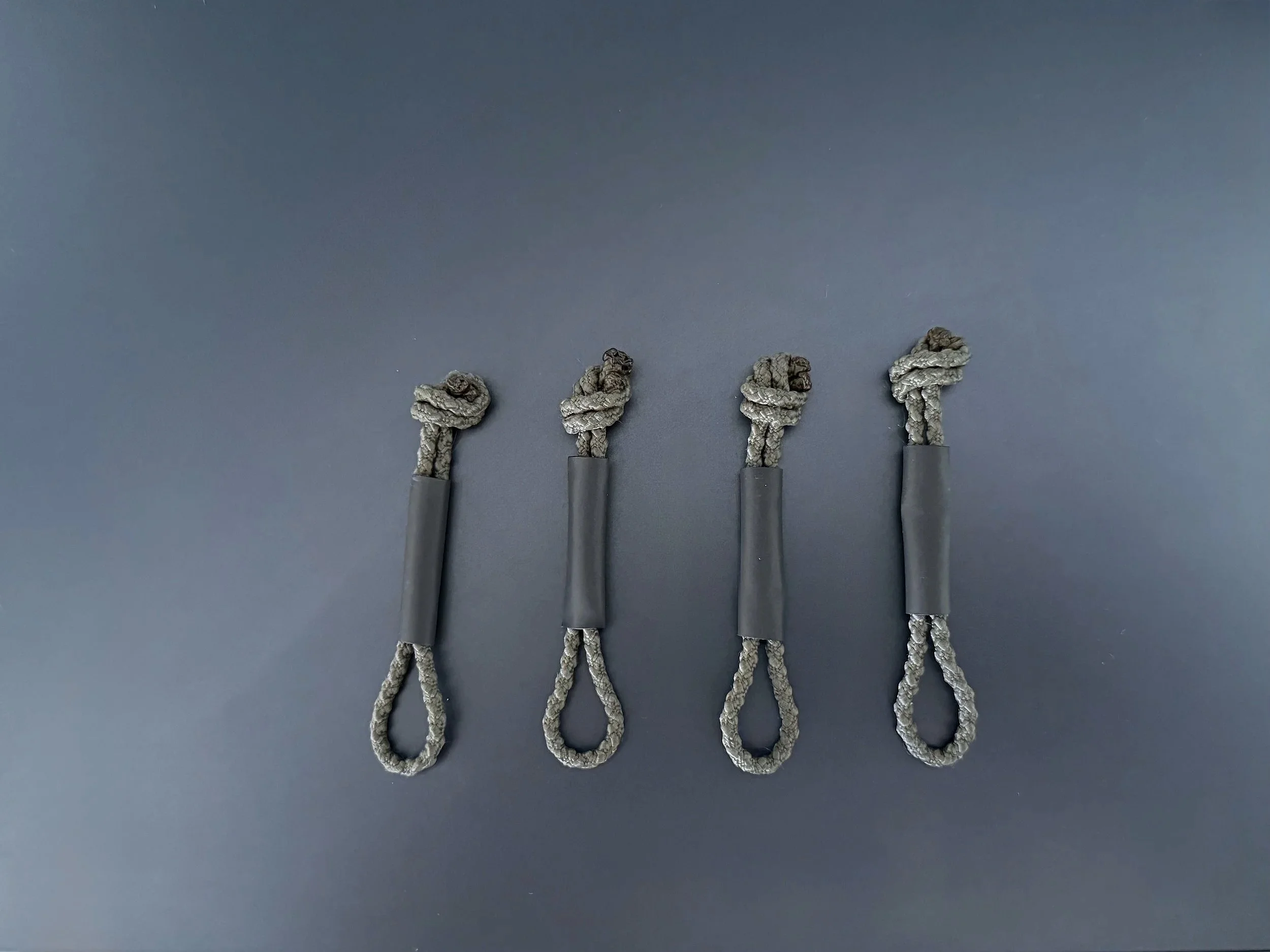 Polymetis Systems Zipper Pulls made from positive locking cord for General Purpose Tactical Pouches with additional shrink tubing for wet environments.