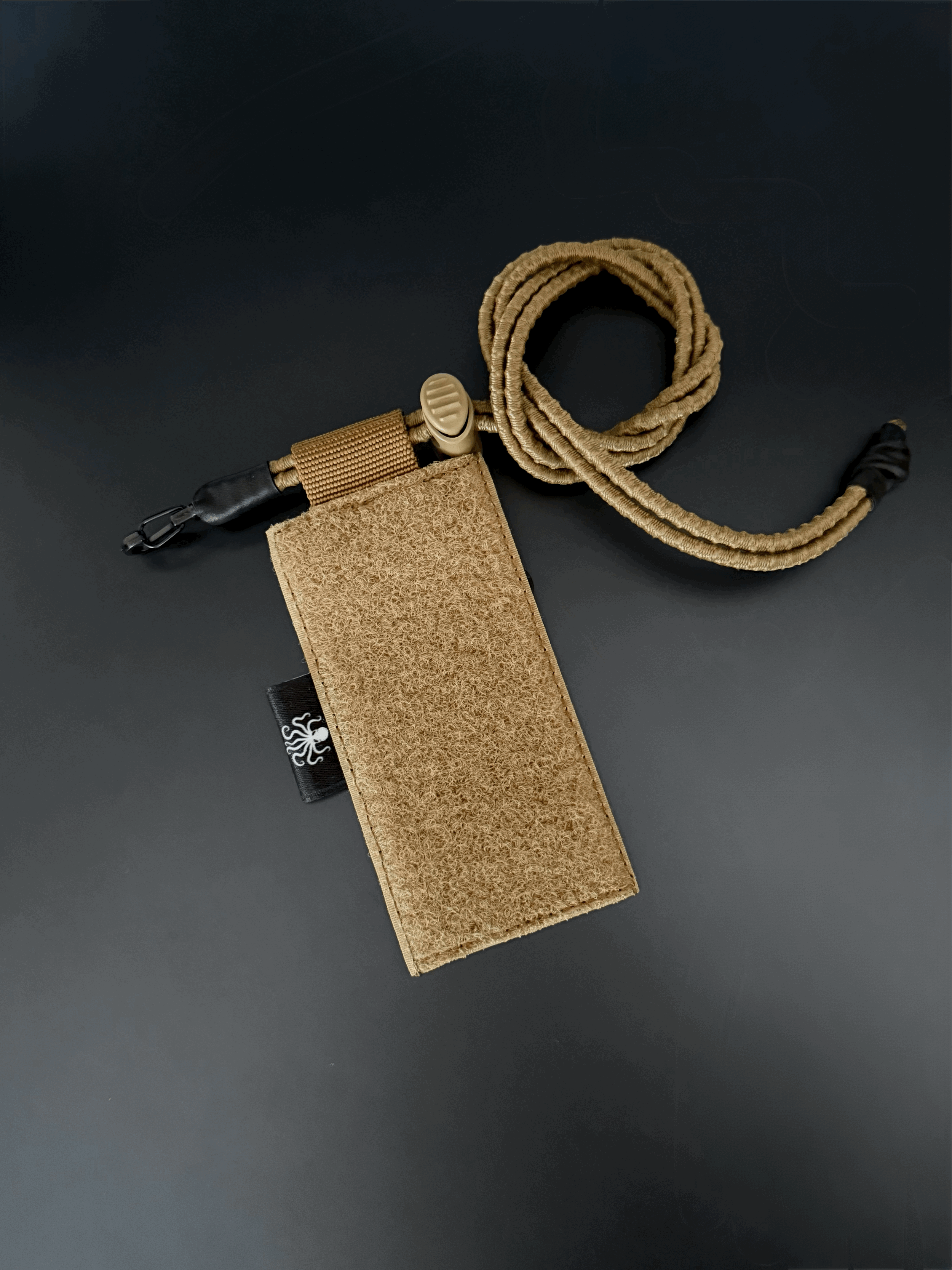 Essential Item Retention Panel EIRP from Polymetis Systems in Tan 499. To lanyard any mission-critical equipment with metal karabiner and elastic shock cord on an Velcro Panel