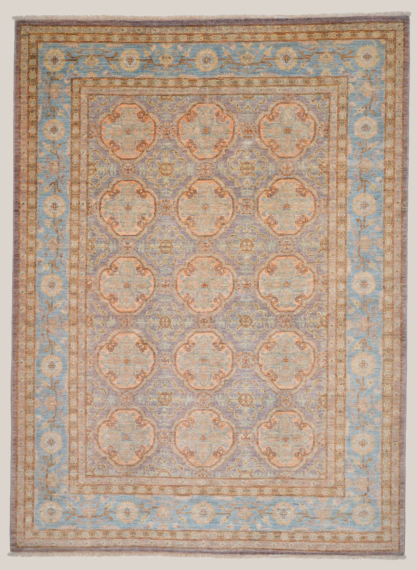 An elegant area rug with a central pattern of large, ornate floral medallions in soft muted tones of beige, blue, and peach. The rug features a decorative border with a floral and vine motif, also in pastel shades, creating a classic and sophisticated design.