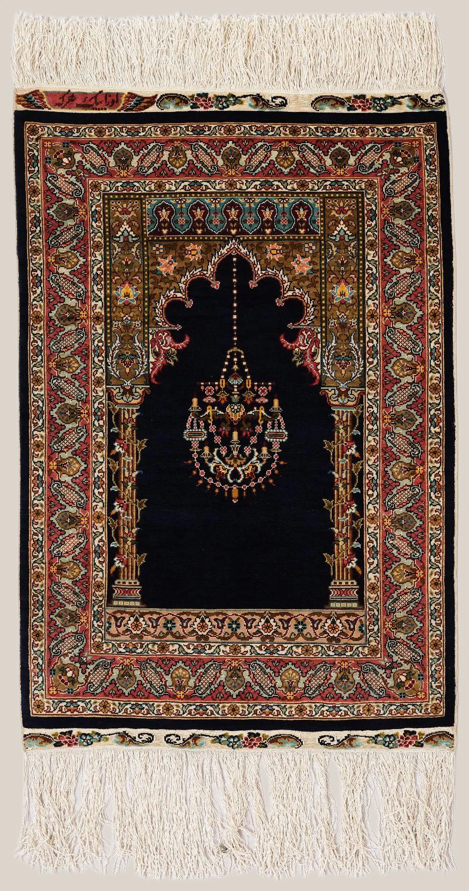 Traditional Persian-style prayer rug with floral and geometric patterns, featuring a central chandelier motif, surrounded by intricate borders of flowers, leaves, and paisley designs in red, beige, black, green, and blue, with fringes on both ends.
