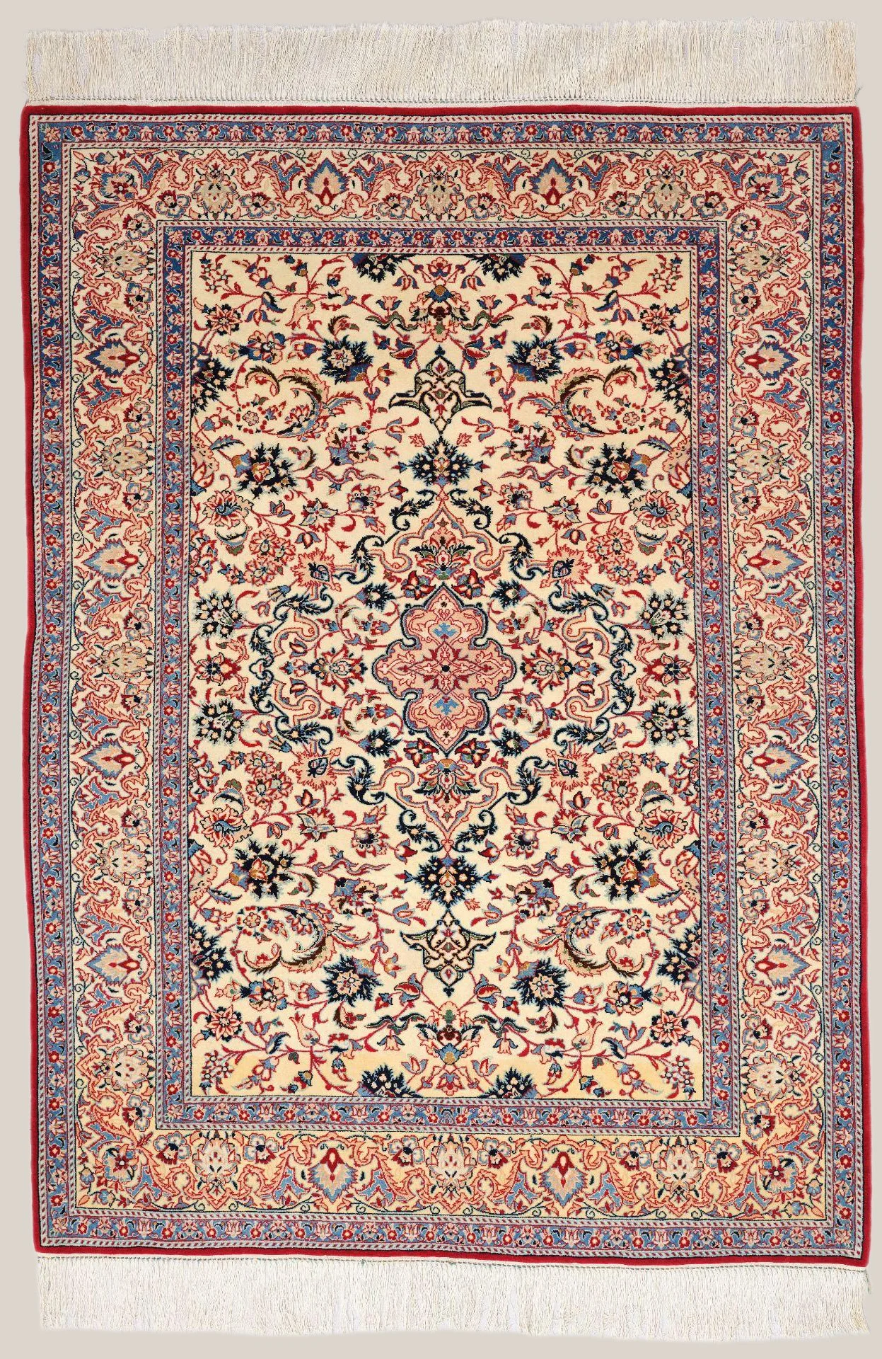 A traditional Persian-style rug with intricate floral and geometric patterns in cream, red, blue, and black colors, bordered by a detailed floral design.