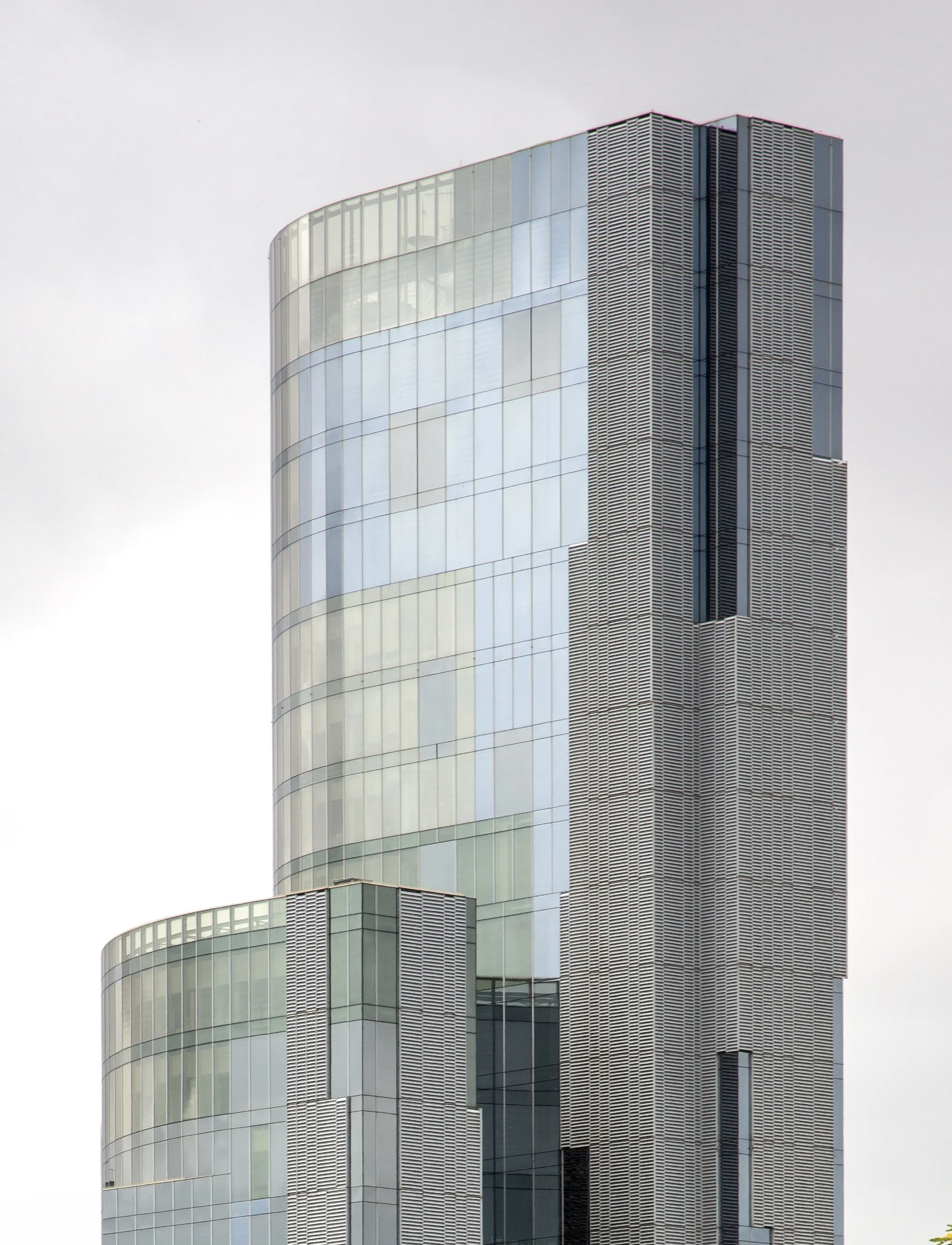 Looking from a distance of a muted sky and soft glass colors of a building in Barcelona