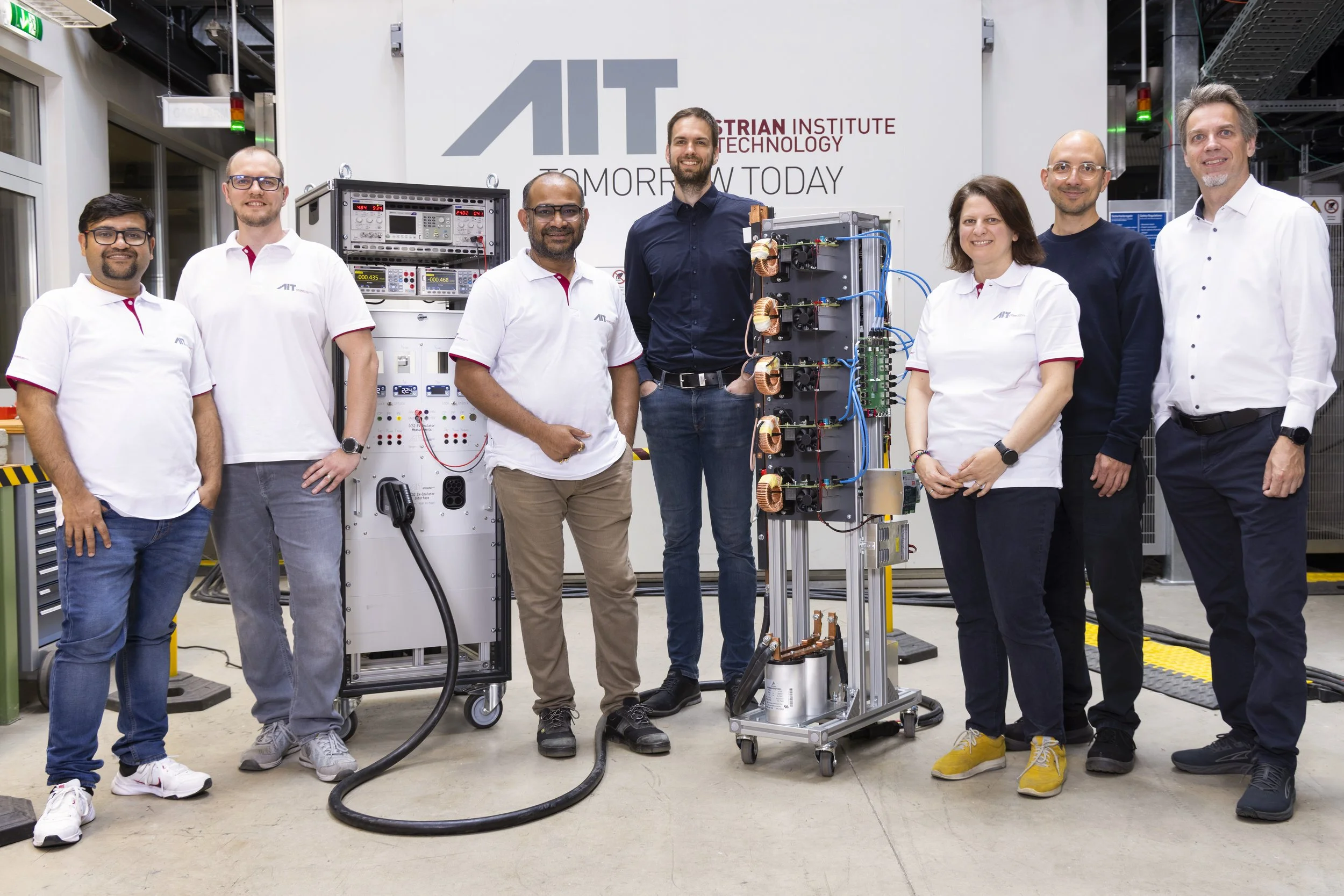 AIT team of the DC Megacharger project in the SmartEST laboratory with DC Megacharger and charging cable.