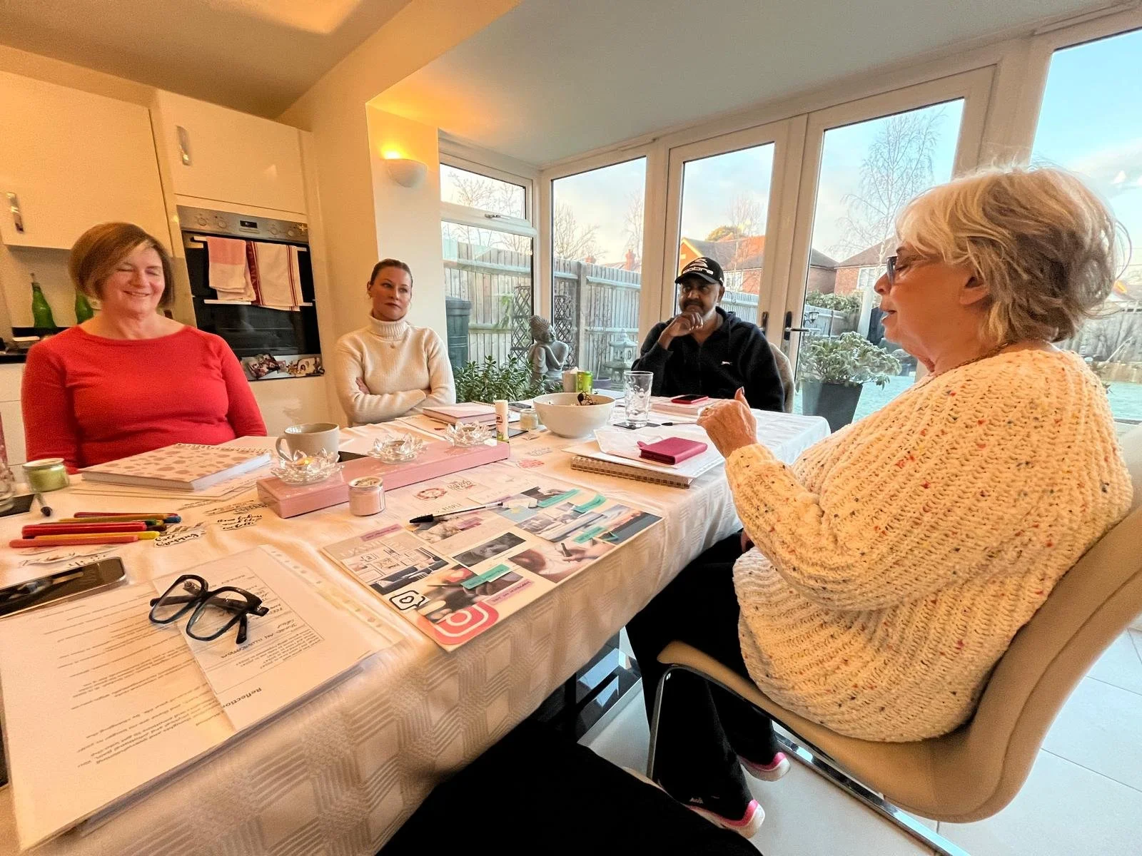 Participants creating vision boards during a small group Manifesting Workshop in Reading