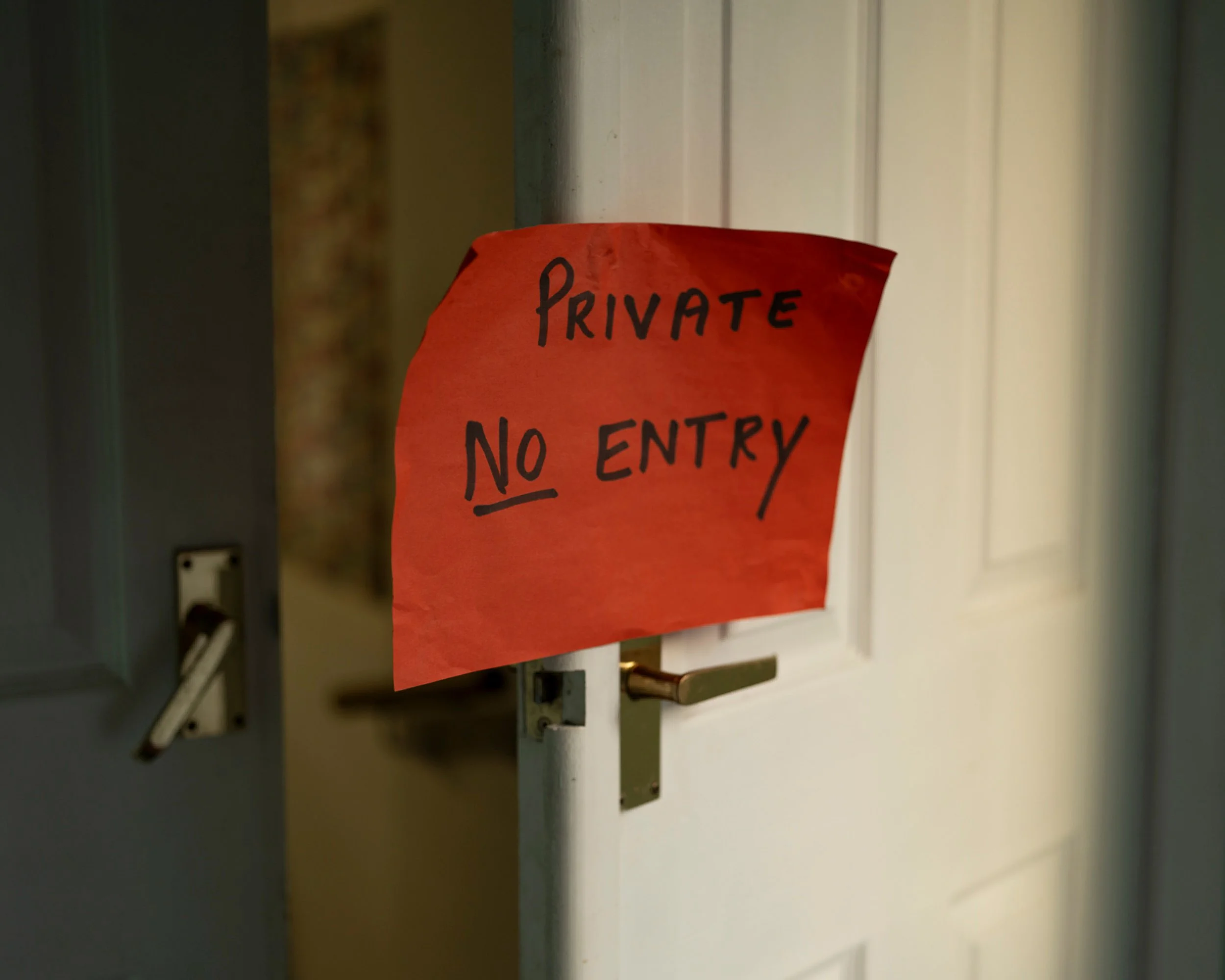 A red paper sign on a door that reads 'Private No Entry' in black handwritten letters.