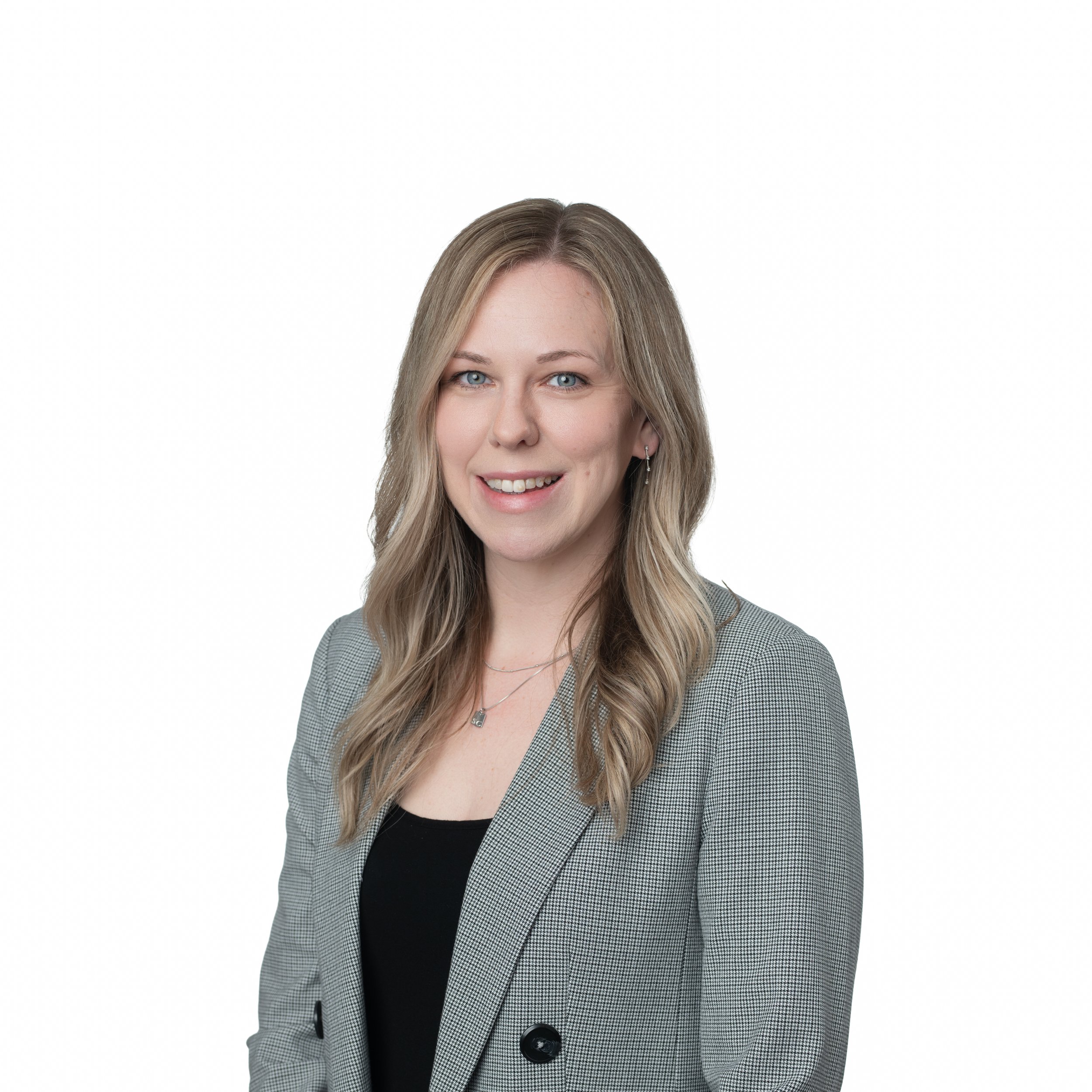 Woman long blonde hair gray suit smiling