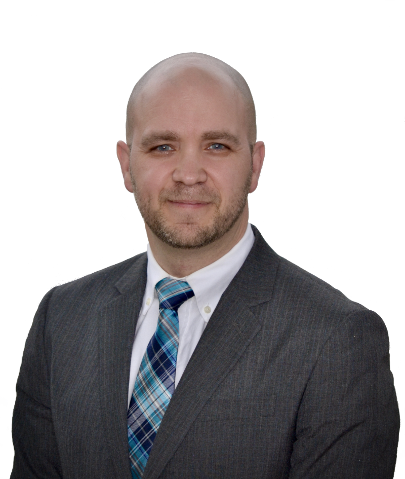 Man with beard dark suit and tie smiling
