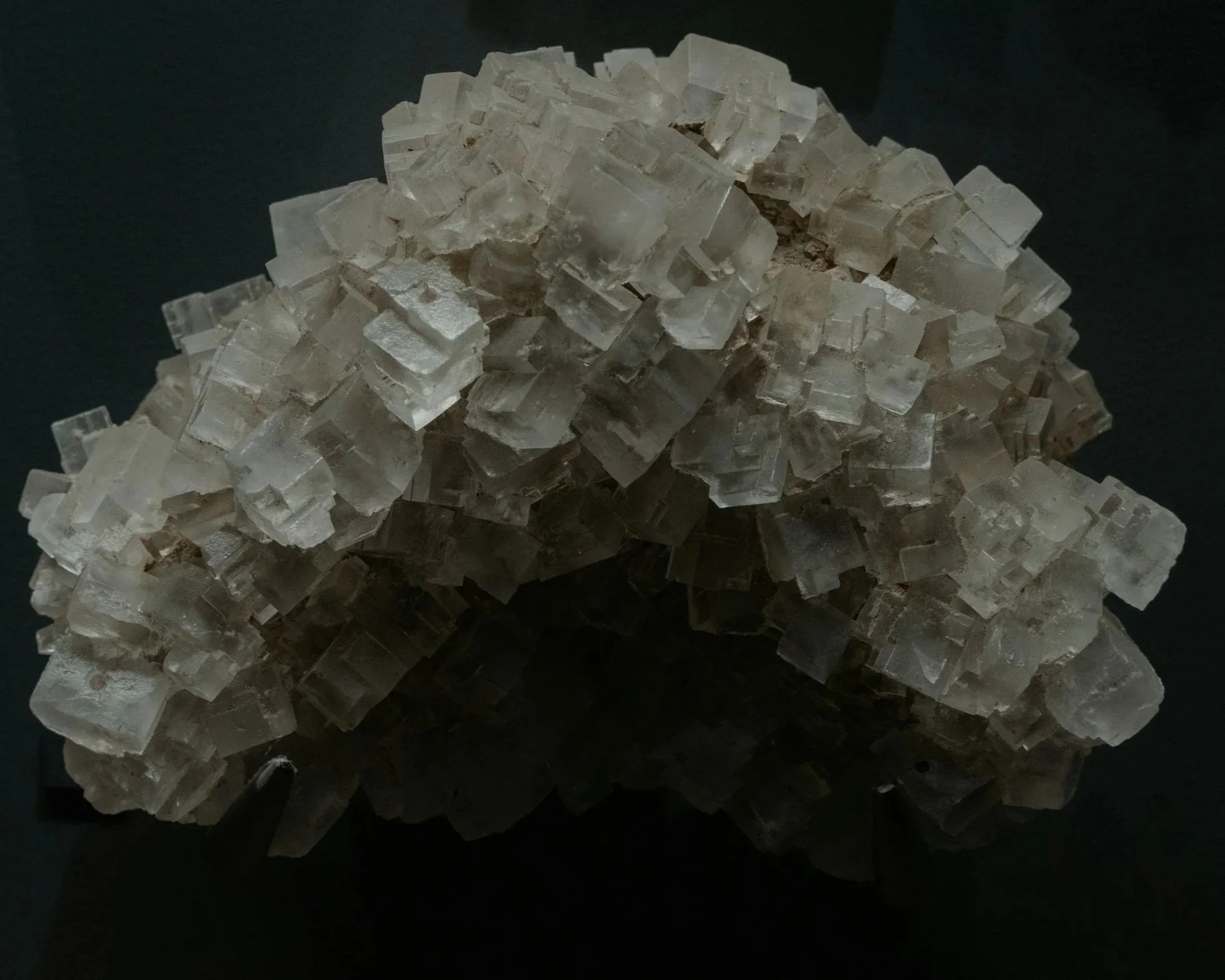 A cluster of clear, cubic salt crystals