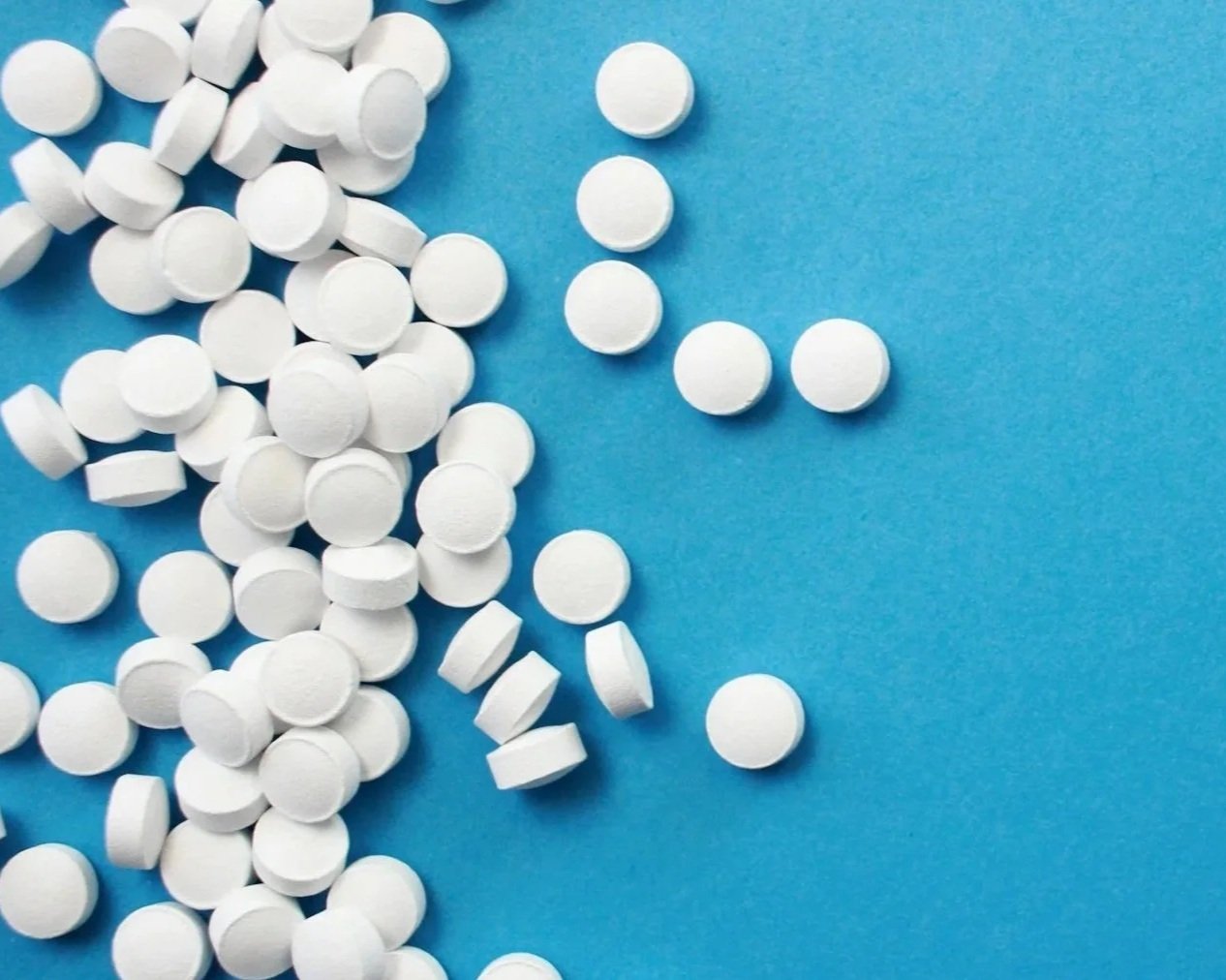 Numeral 4 spelled out with white pills on a blue background.