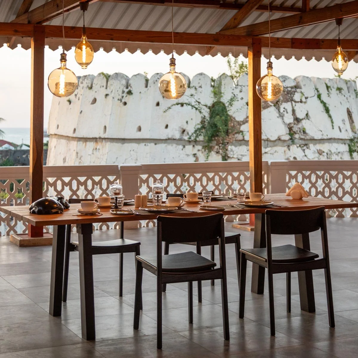 Enjoy stunning views from the upper deck at a beautifully set dining table.