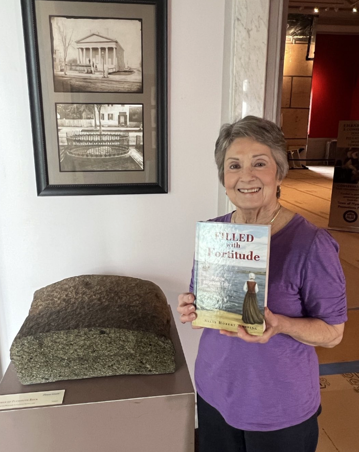 Sally with her newly published novel at Pilgrim Hall Museum in Plymouth, Massachusetts.