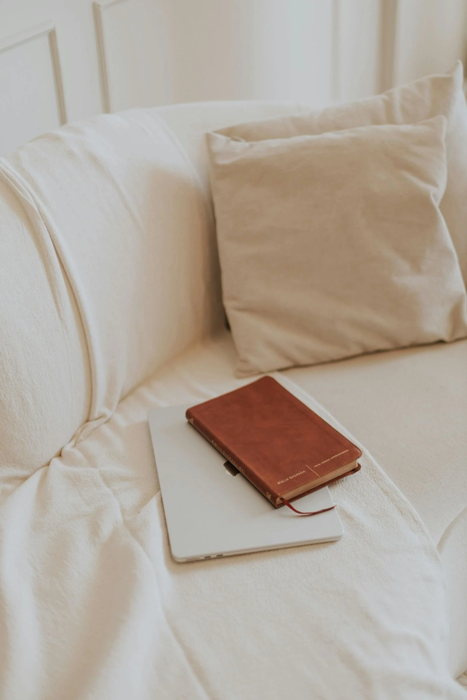 couch with a journal and a book
