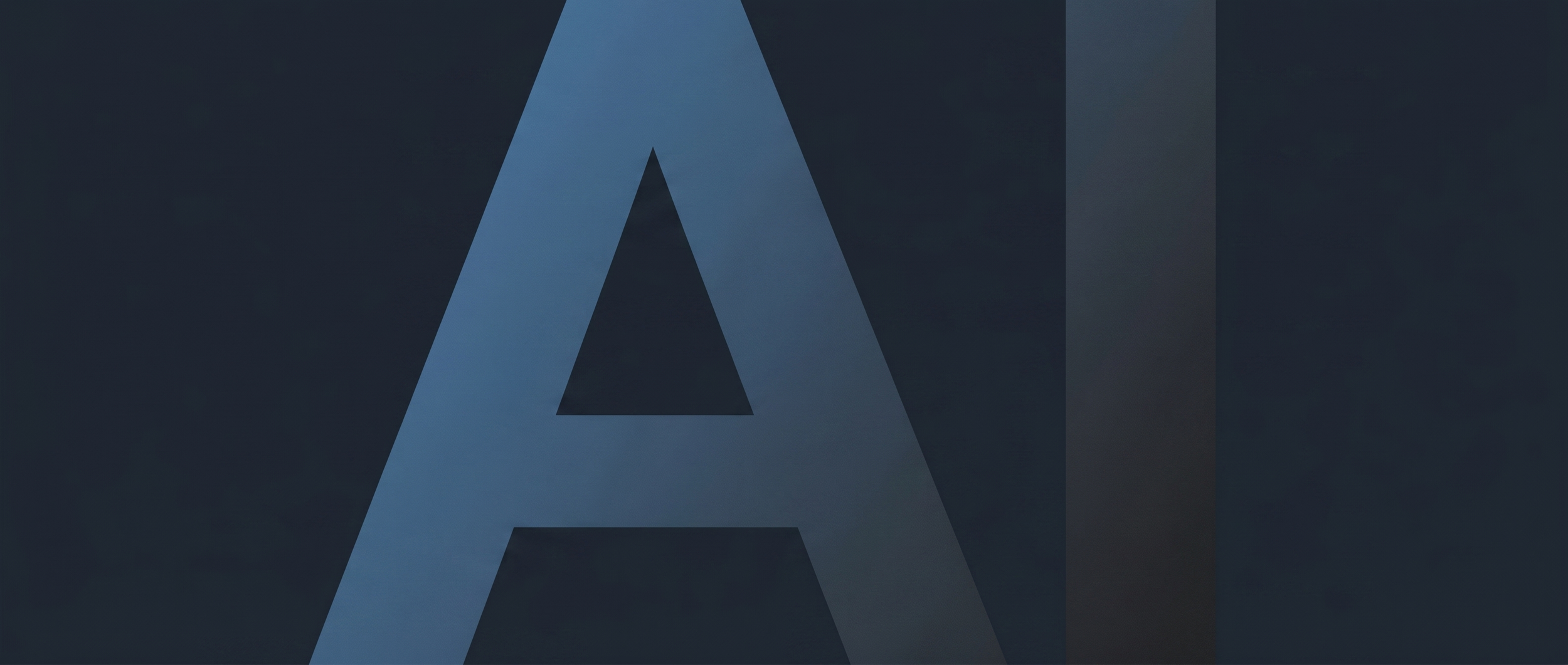 Close-up of the letter A in a stylized font on a dark background.