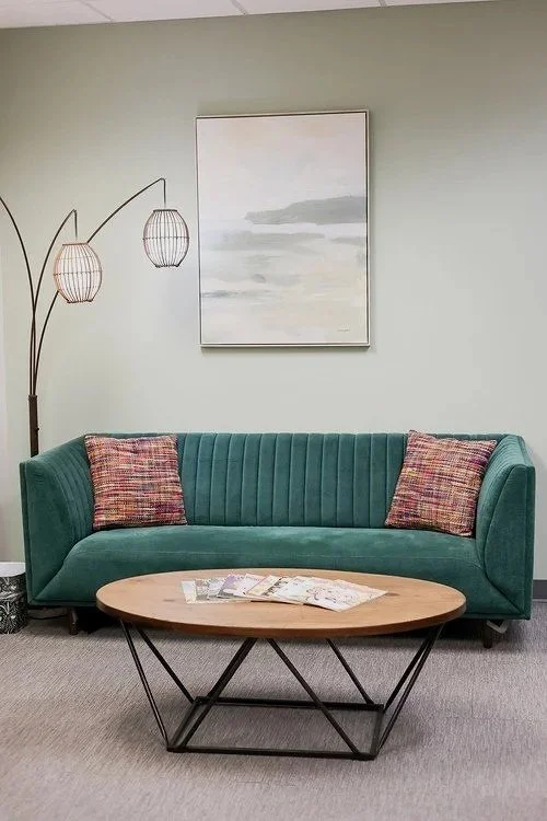 office space couch in lobby for clients for wellness