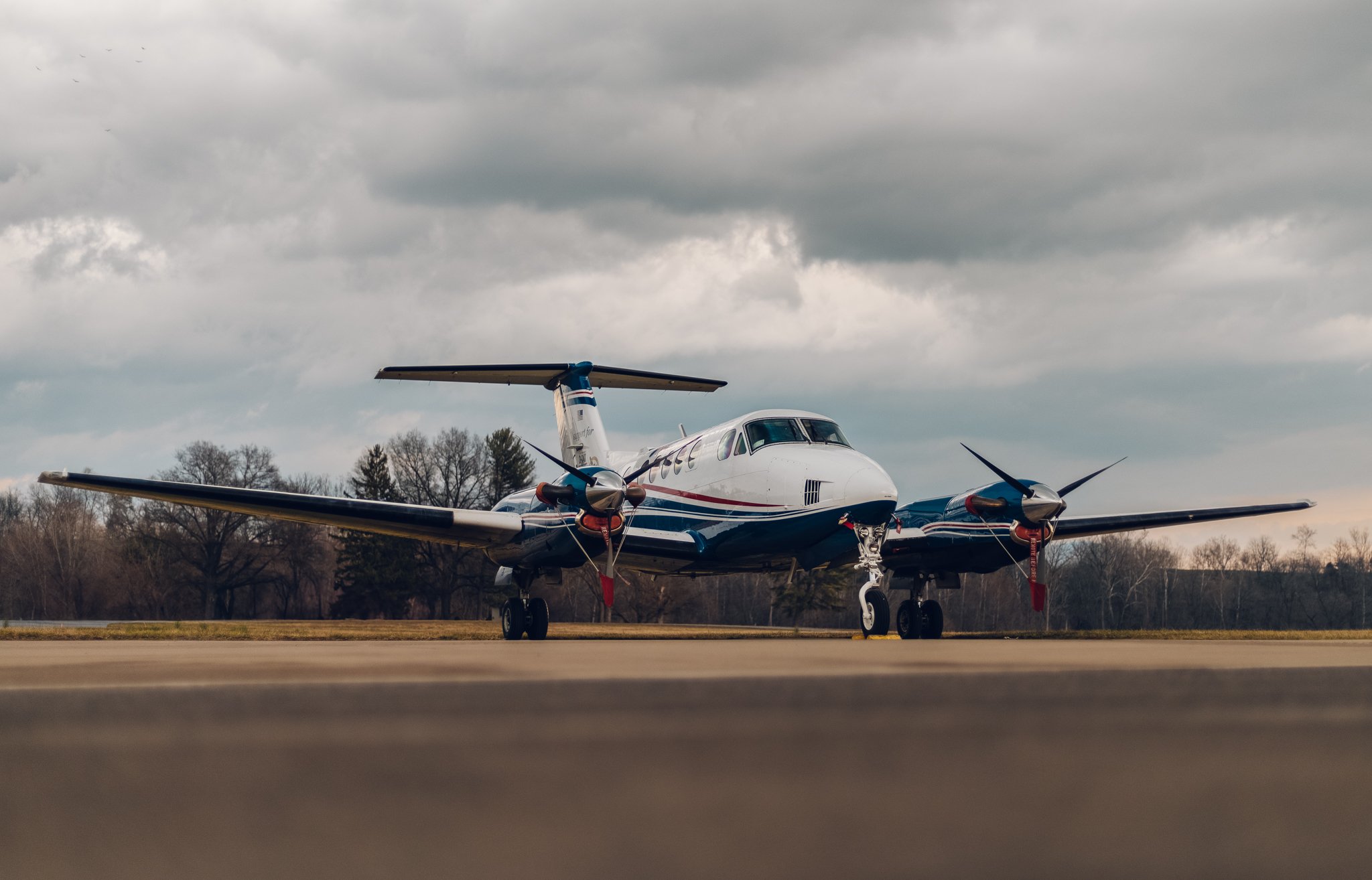 A Dynamic Aviation aircraft on the ramp under a stormy sky