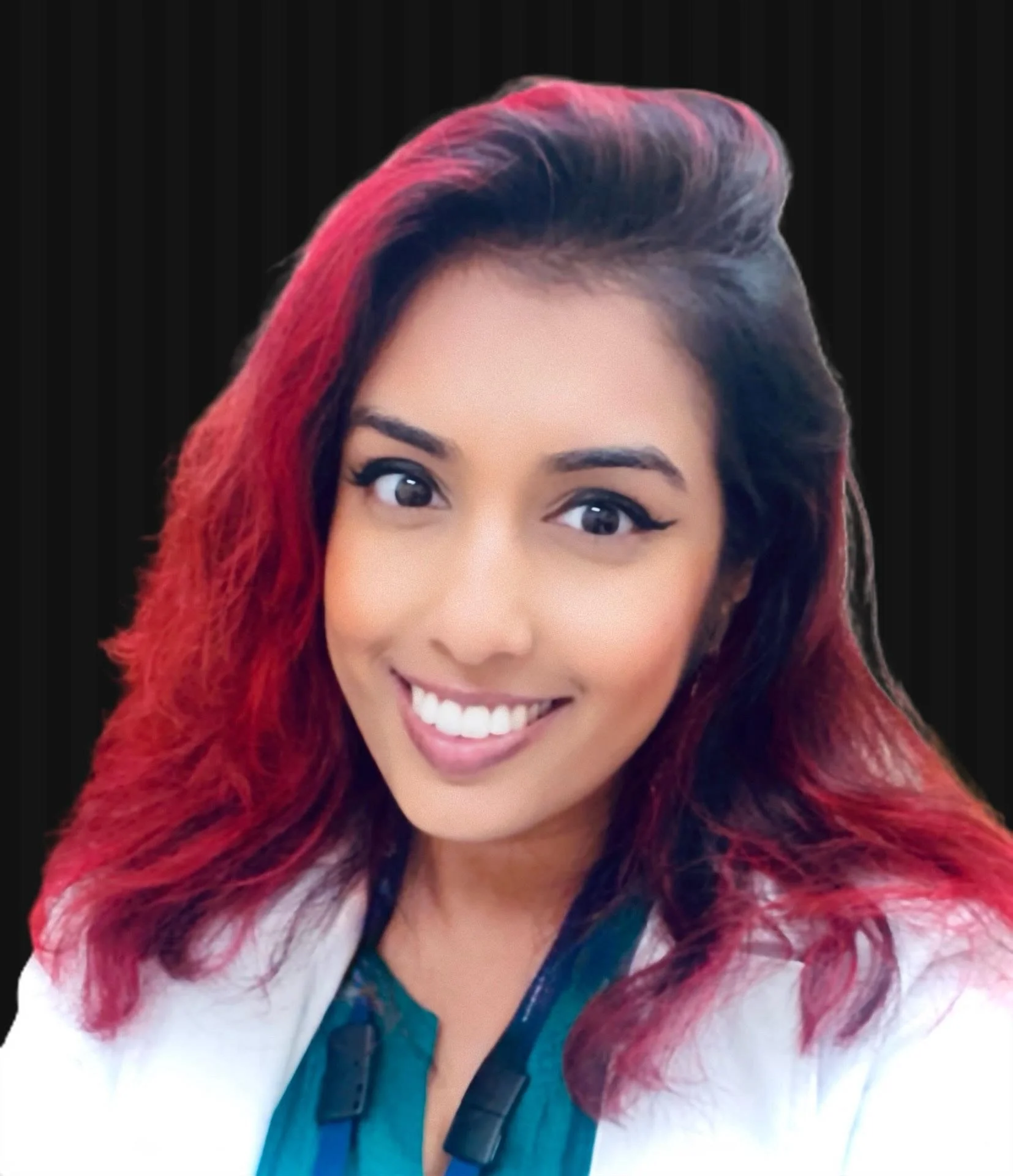 A smiling woman with shoulder-length wavy hair wearing hoop earrings, a white top, and a navy blazer, standing against a plain white background.