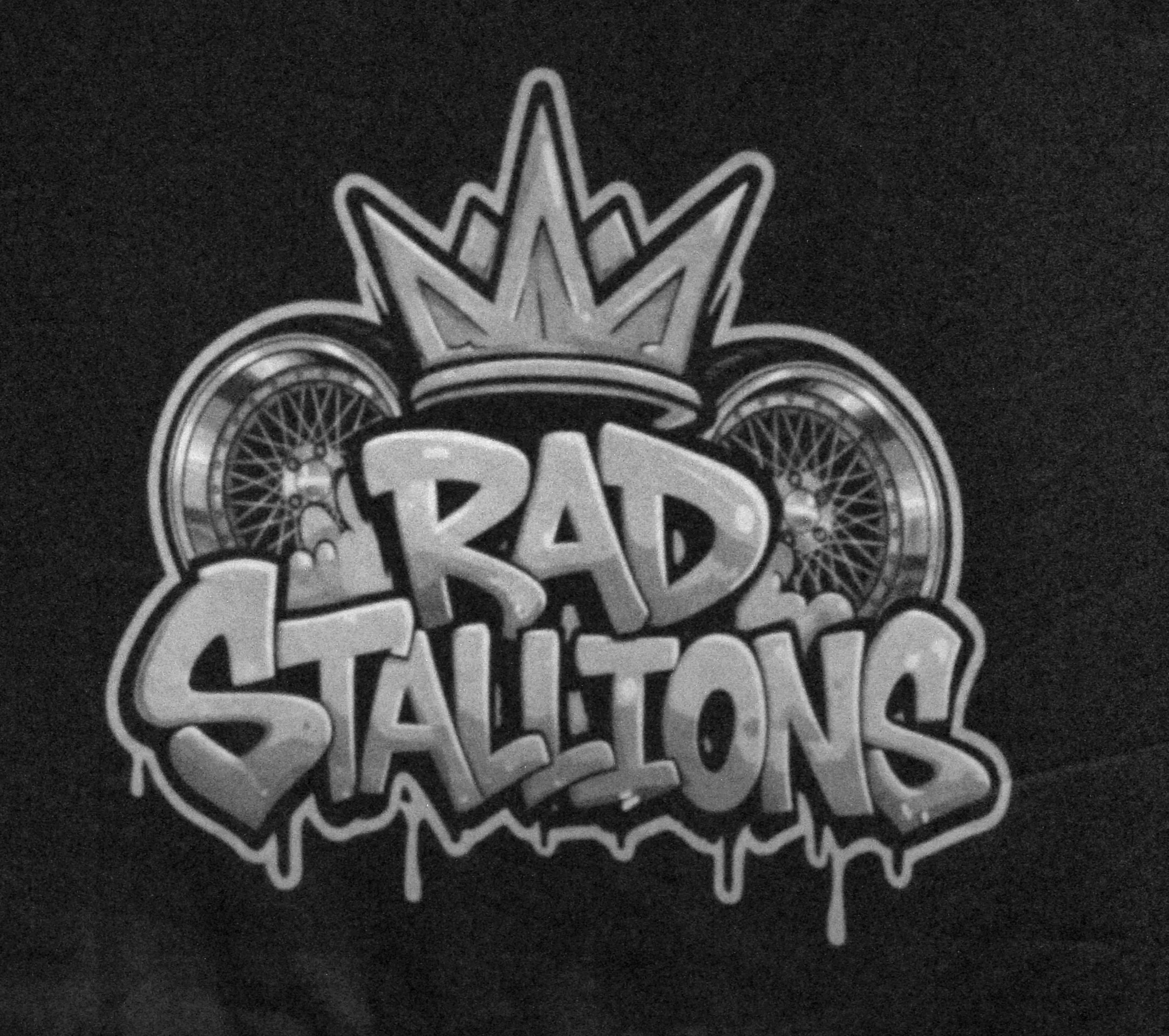 Close-up of a logo featuring the text 'ROAD' and 'STAY' with road wheel designs and a crown-like shape above the text, on a dark background.